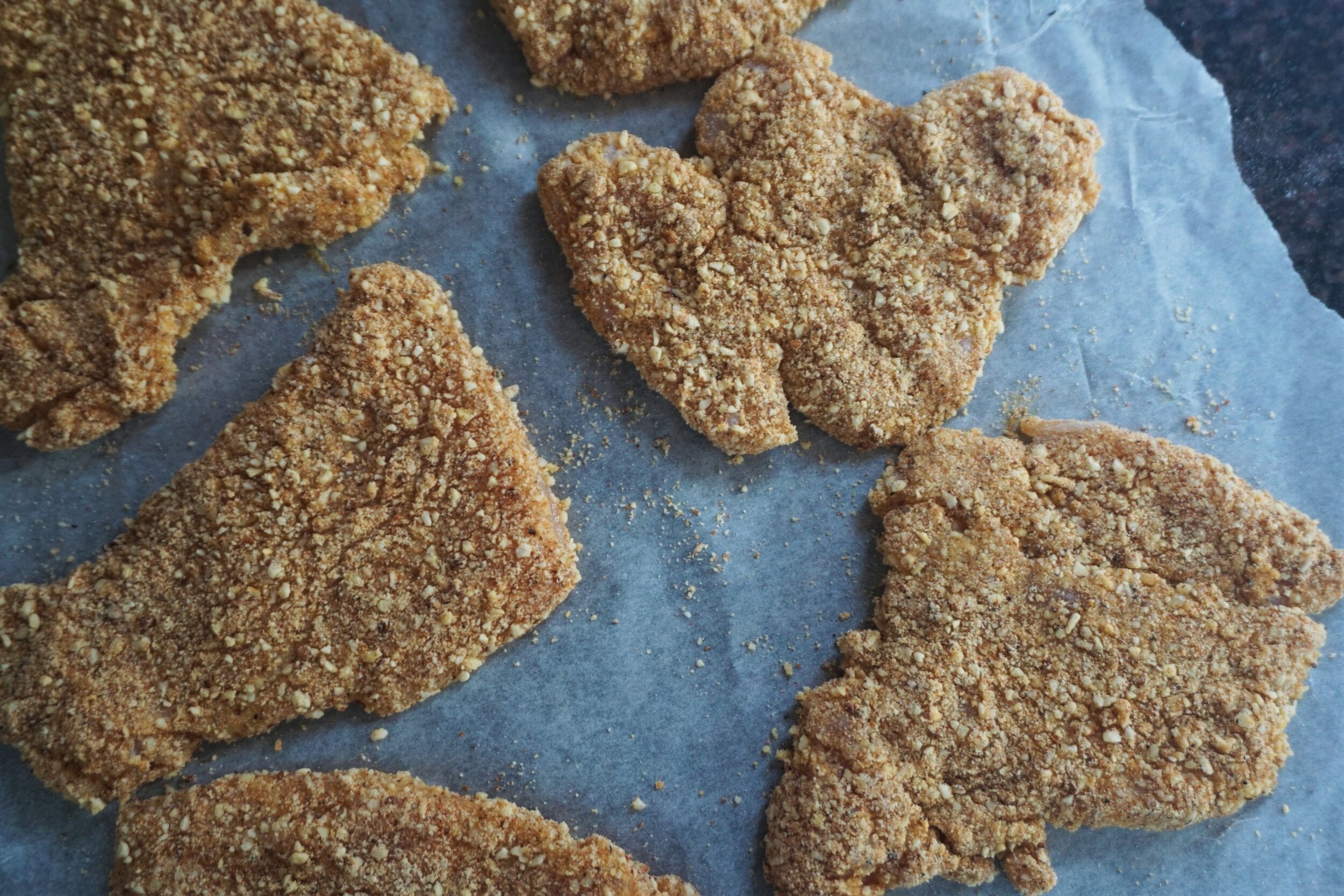 The chicken is coated, now it rests while the oil is heated for frying.