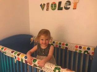 And then . . . a distraction comes about, but - it's a cute one by the name of Violet (name on the wall proves it). She just woke up from her nap inside. Whew - she's smiling and that's a good thing after a naptime.