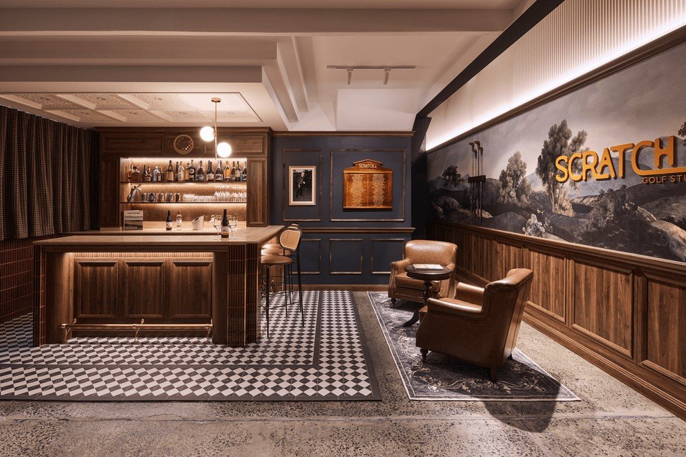 Indoor golf studio bar design with dark wood cabinetry and tiled floor by Al and Co Haus of Design in Sydney.