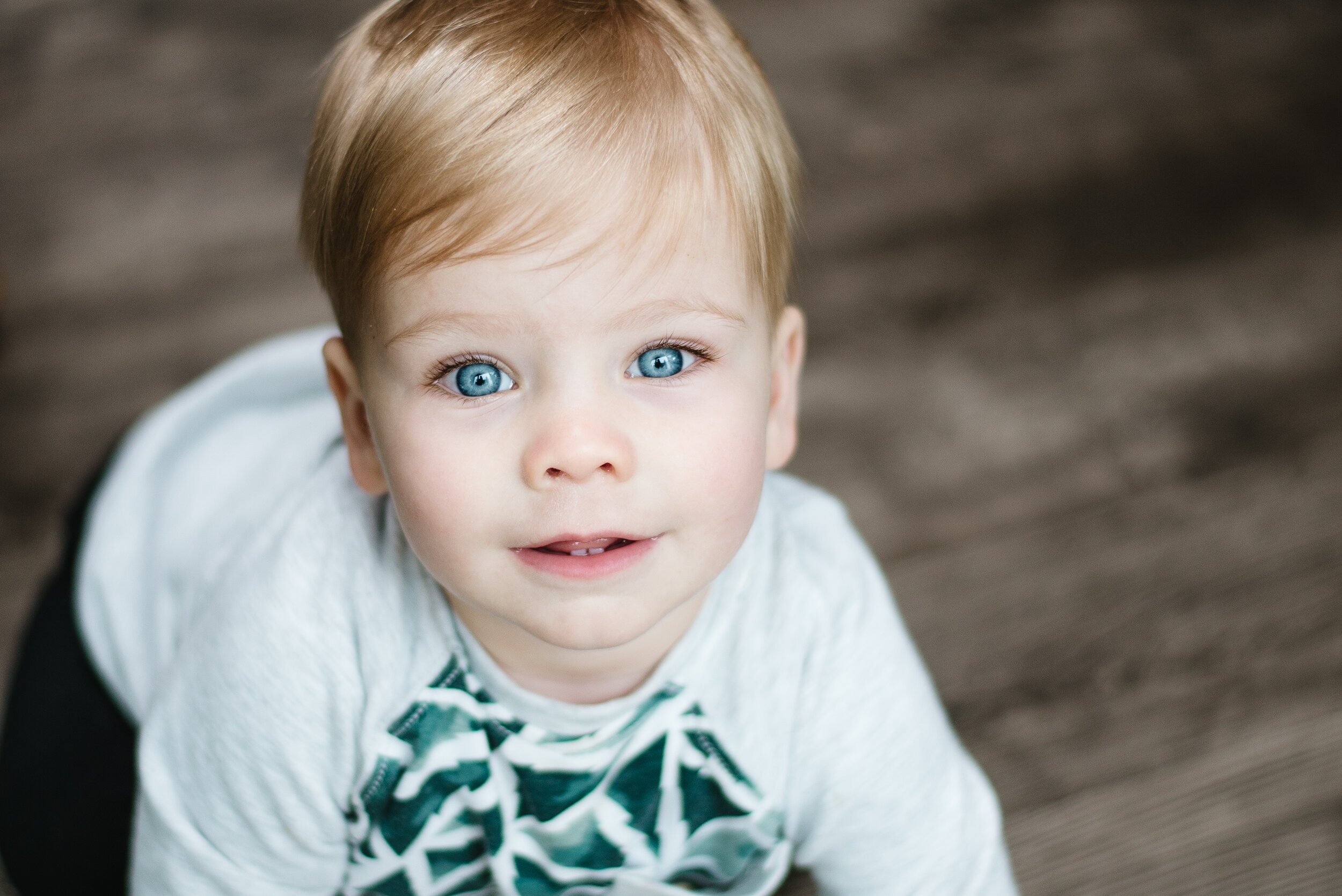 one year old boy with stunning bright blue eyes and blond eye