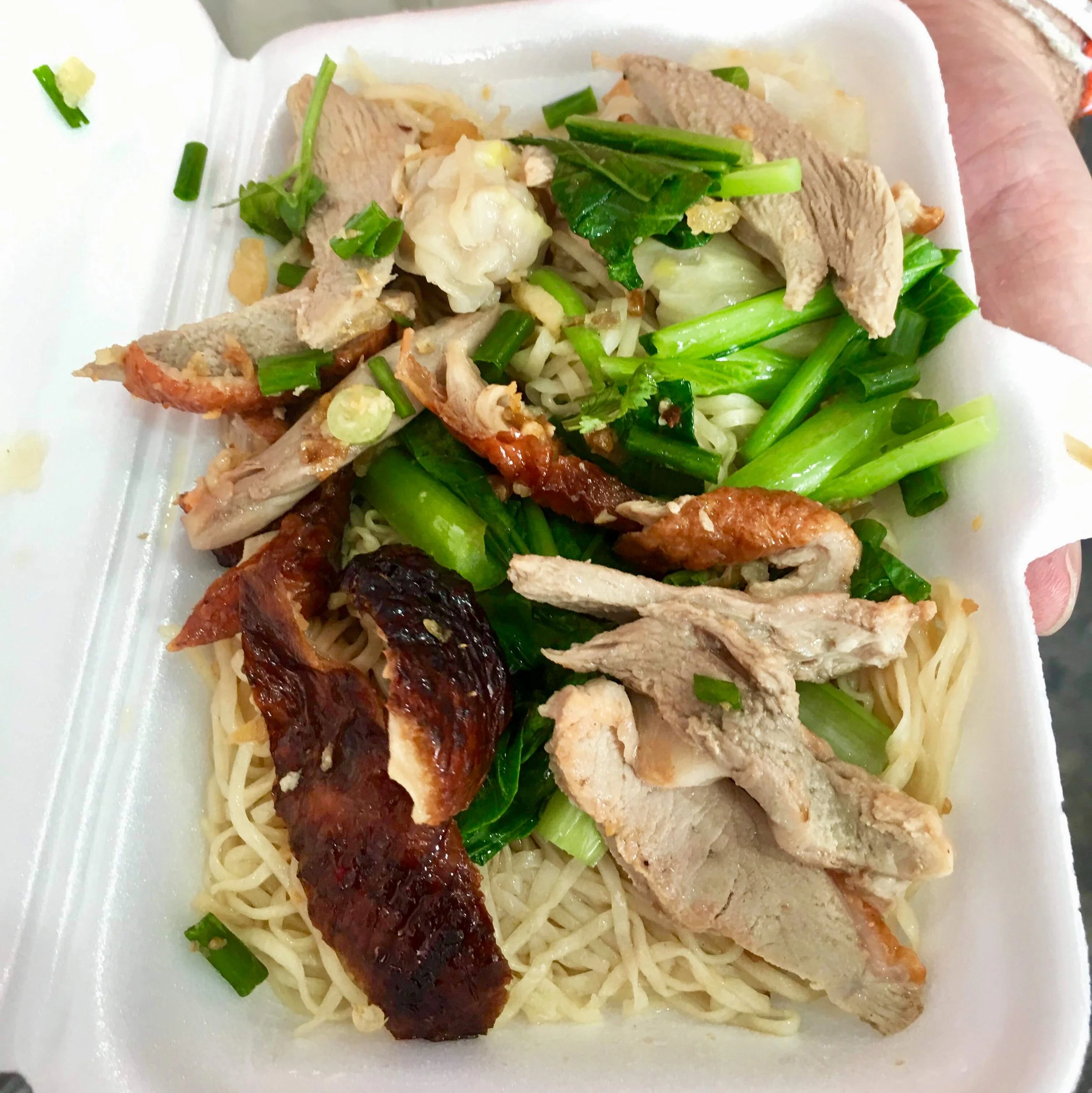 Bami Ped (duck noodles) provided for free by merit-making temple-goers near Bobae Market in Bangkok
