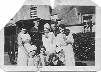 Outside the big house - Grace sitting on one of the servants knees with mother Janet next to her (without a hat) and father Robert at the back with his arms draped around two ladies