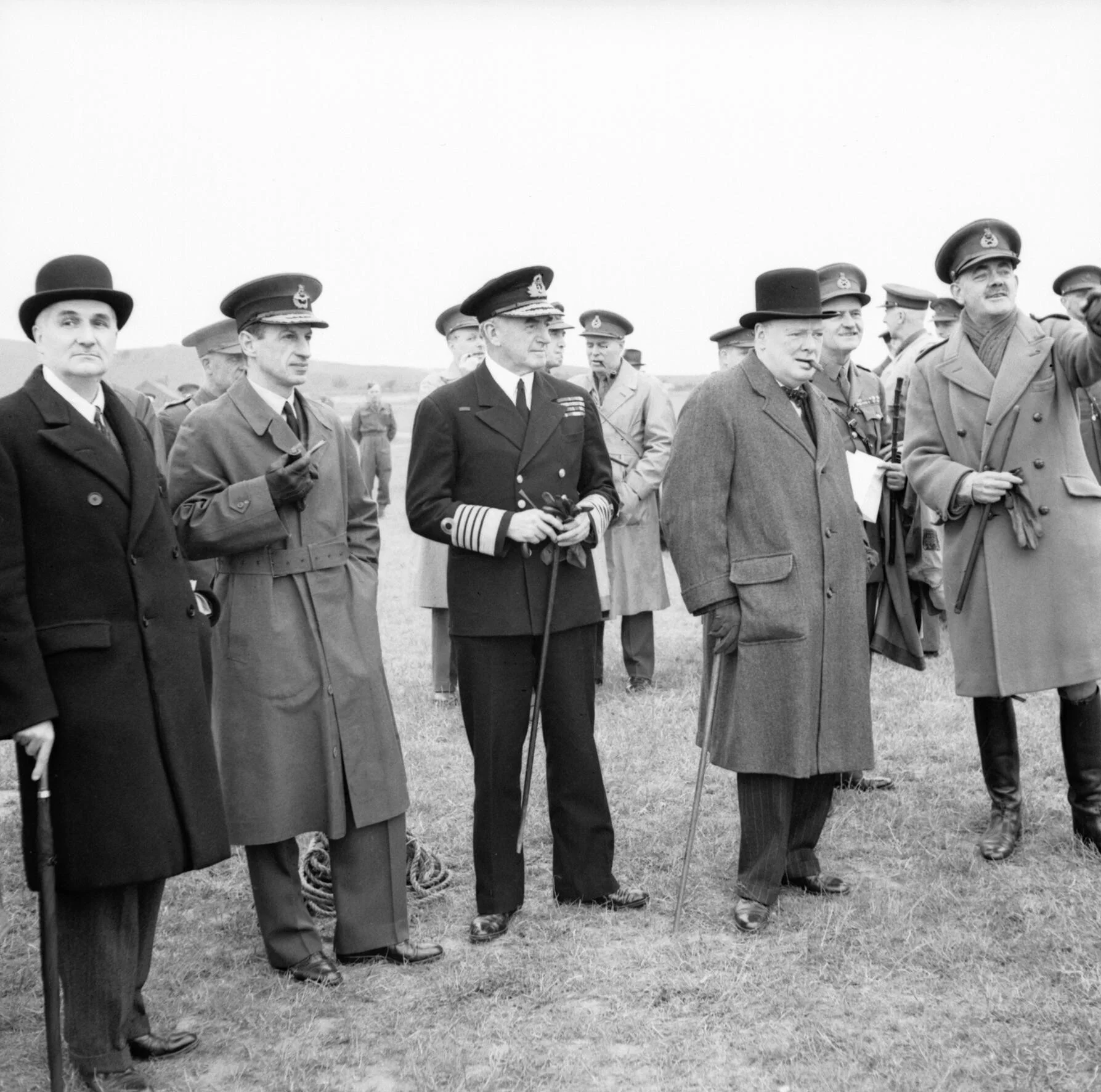 Winston Churchill with his scientific advisor Lord Cherwell (furthest to the left), Air Chief Marshal Sir Charles Portal and Admiral of the Fleet Sir Dudley Pound, watching a display of anti-aircraft gunnery, June 1941. Photograph owned by the Imperial War Museum.