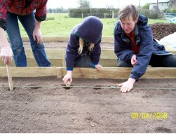 Vita and her mum Nancy planting the first spuds.