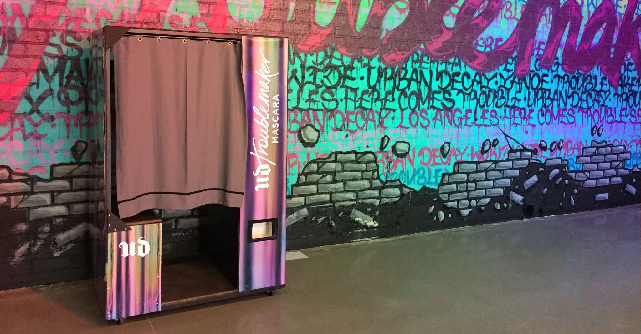 Photo of custom marketing photo booth wrapped in branding for Urban Decay cosmetics.