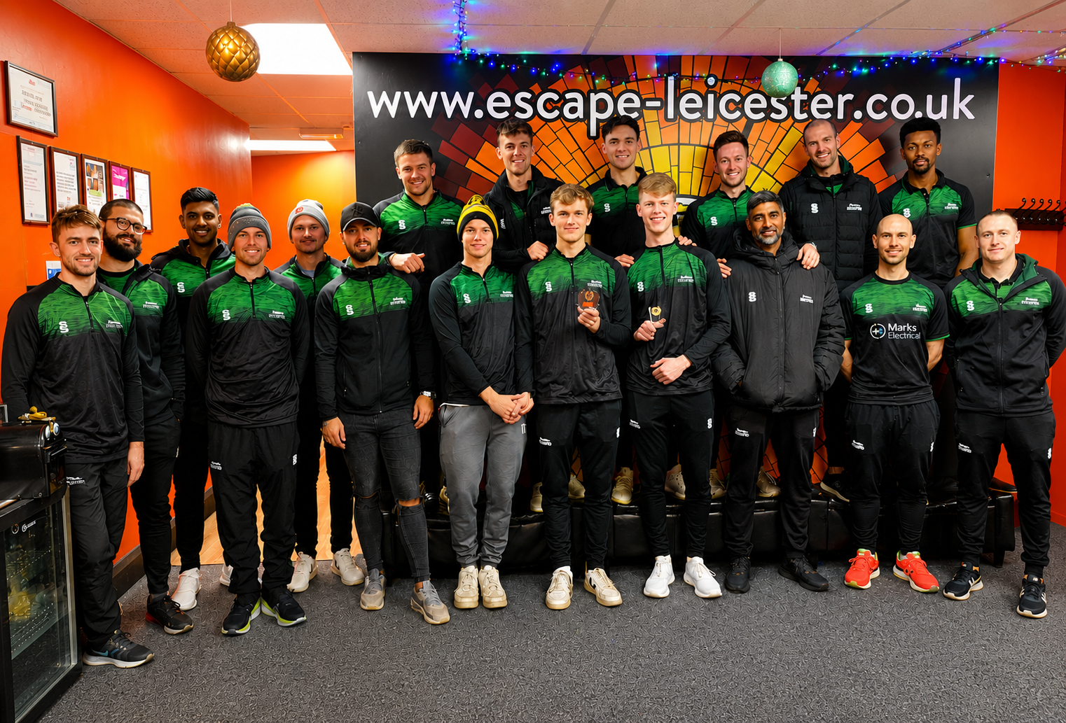 Group of players celebrating after completing an escape room challenge at Escape Leicester