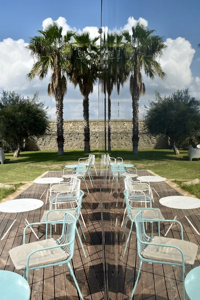 Reflections cafe and palm trees Syracuse Italy