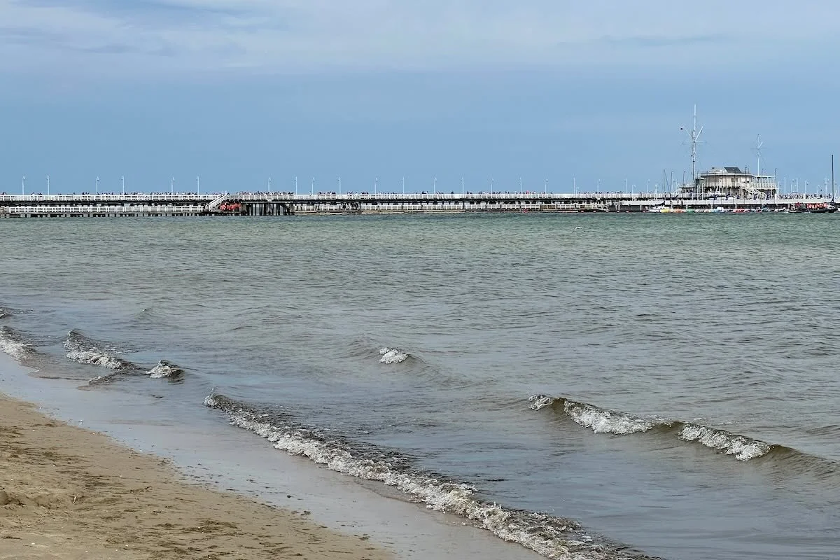 Travel Tips Tuesday inspiration from the grand Baltic seaside resort of Sopot, just a short train ride from the main train station in Gdansk Poland, where the gently sloping beach, a long wooden pier, elegant beach hotels, and beautiful gardens with 
