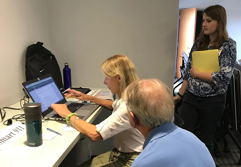 UD student Christine Hoh helped seniors register for the Smart 911 system at a workshop led by Coastal Hazards Specialist Danielle Swallow.