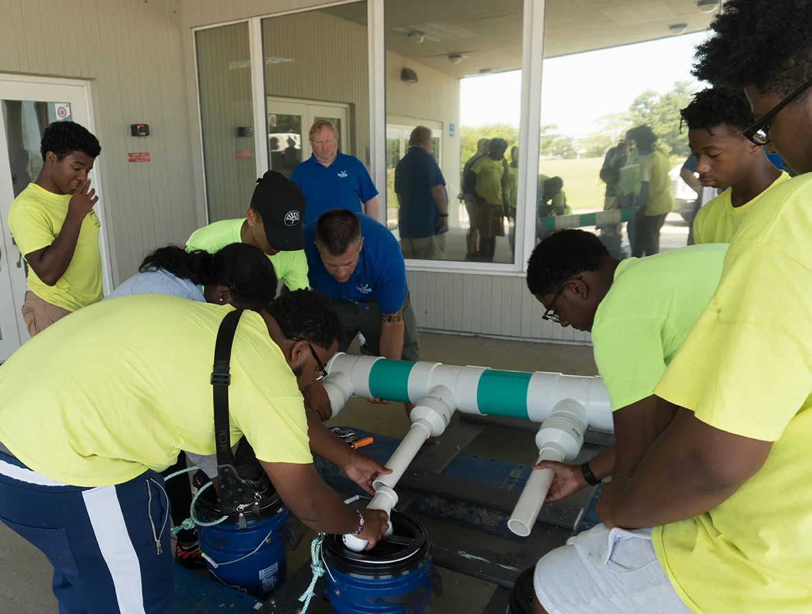 Wilmington Green Jobs participants assemble a Floating Upweller System, or FLUPSY, with Marine Advisory Service specialists Ed Hale and David Christopher (in background). The FLUPSY will be used for Delaware Sea Grant’s oyster aquaculture demonstration project.