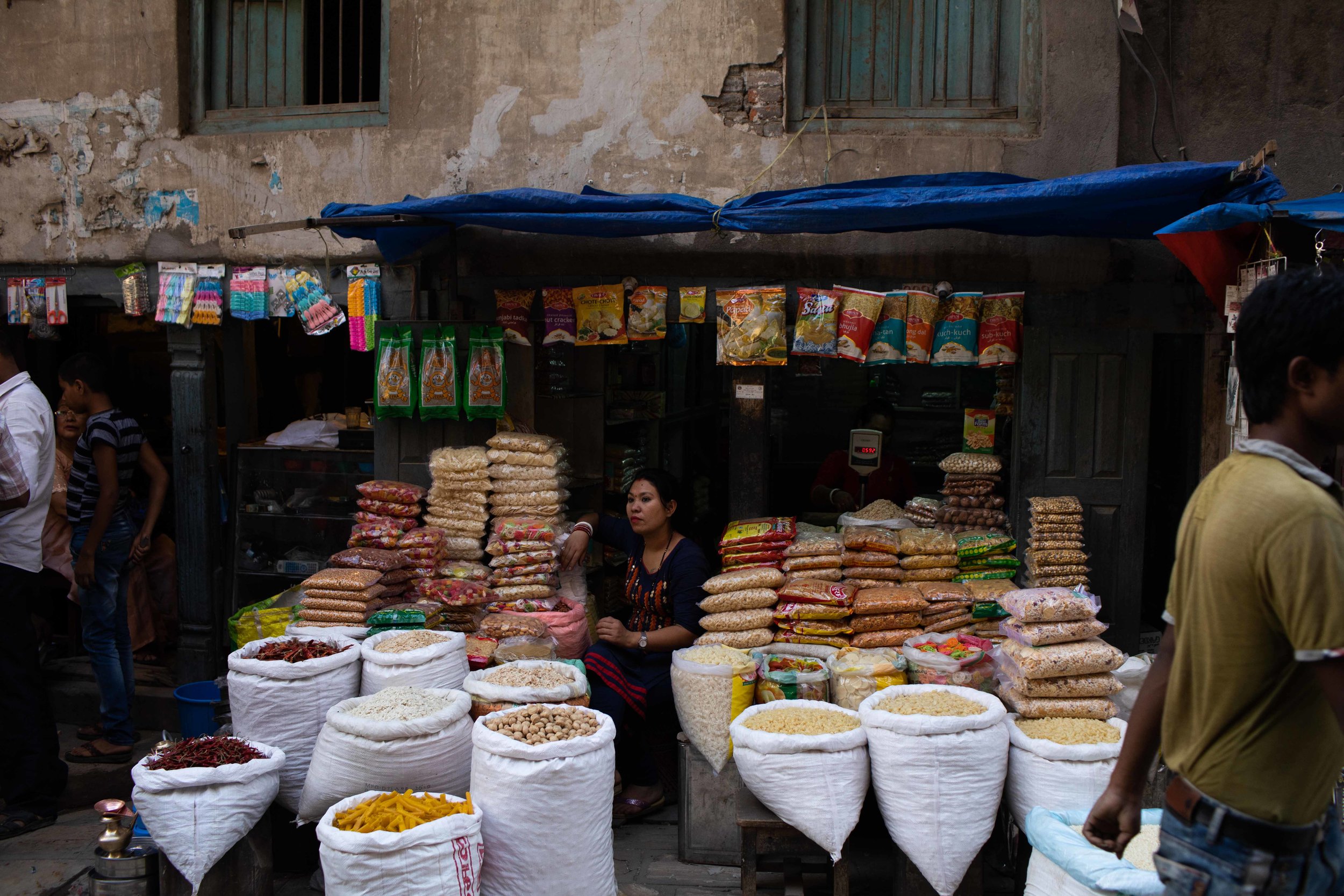 A woman sells spices outside a shop in Thamel, cardamon is one of Nepal’s exports from the Himalayas.
