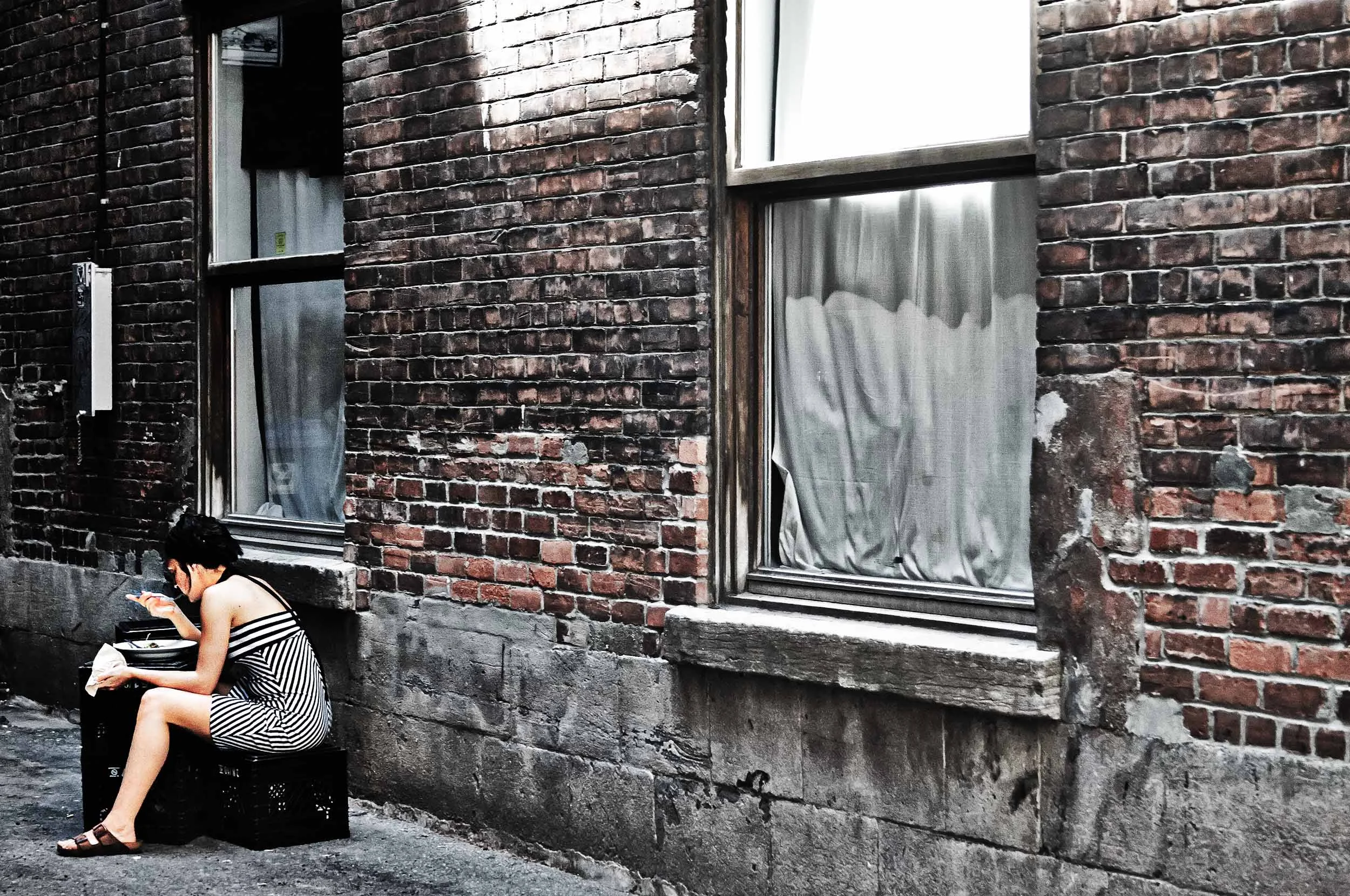 Montreal-Woman-Eating-Down-An-Alley.jpg