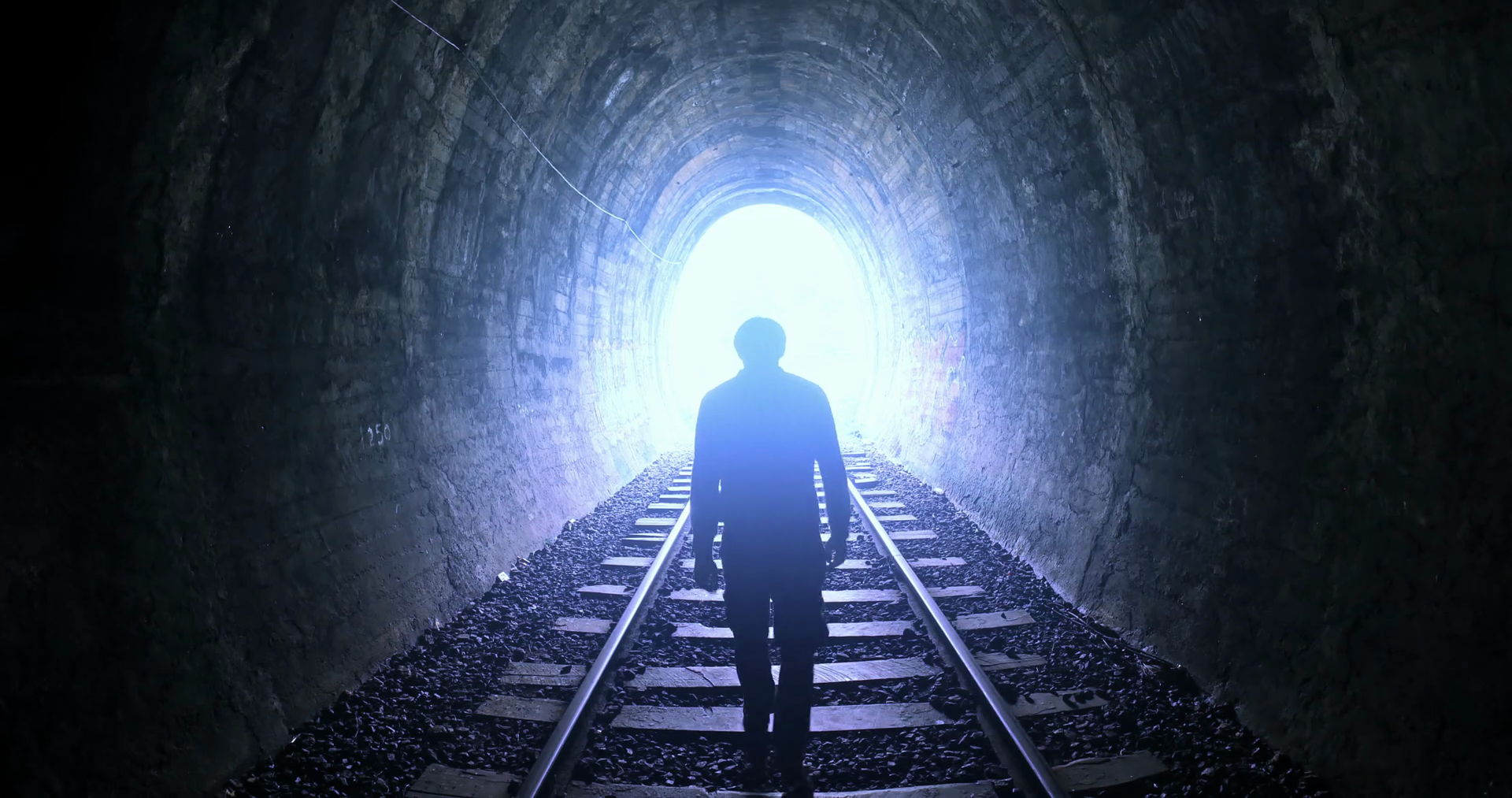 man-goes-by-railway-tracks-through-dark-tunnel-toward-bright-light-in-the-end_bi7r2o1ex_thumbnail-full01.png