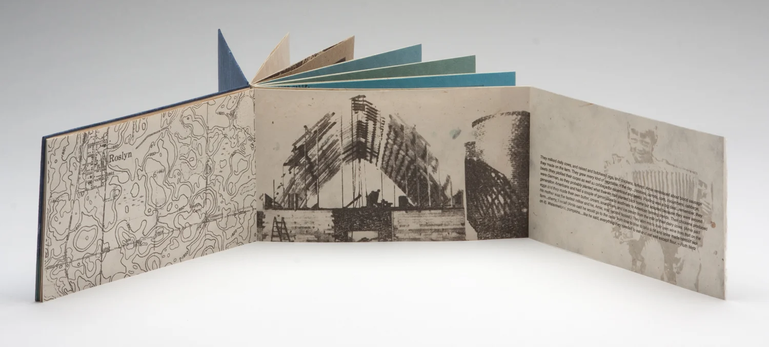 First gatefold completely opened. Gocco printed photograph of the family barn being rebuilt after a tornado, photograph of Arnie as a child; and text written by his wife on what the family raised on the farm.