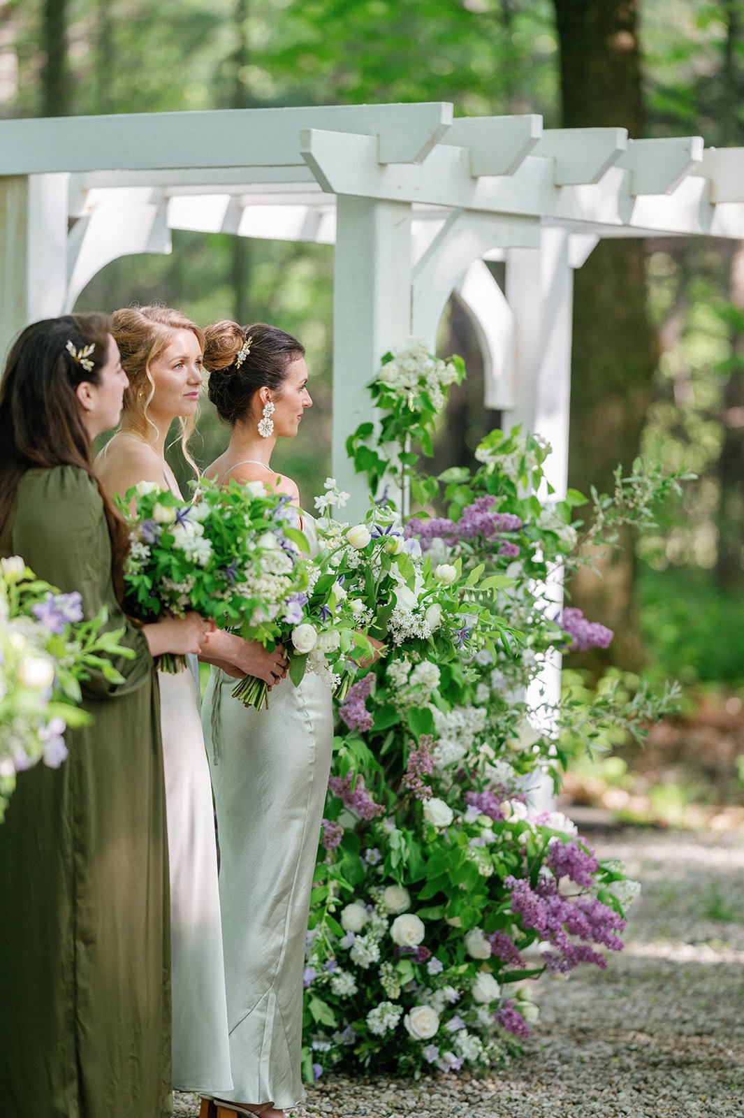 Bridesmaids Stand in Front of Extravagant Altar Piece   
