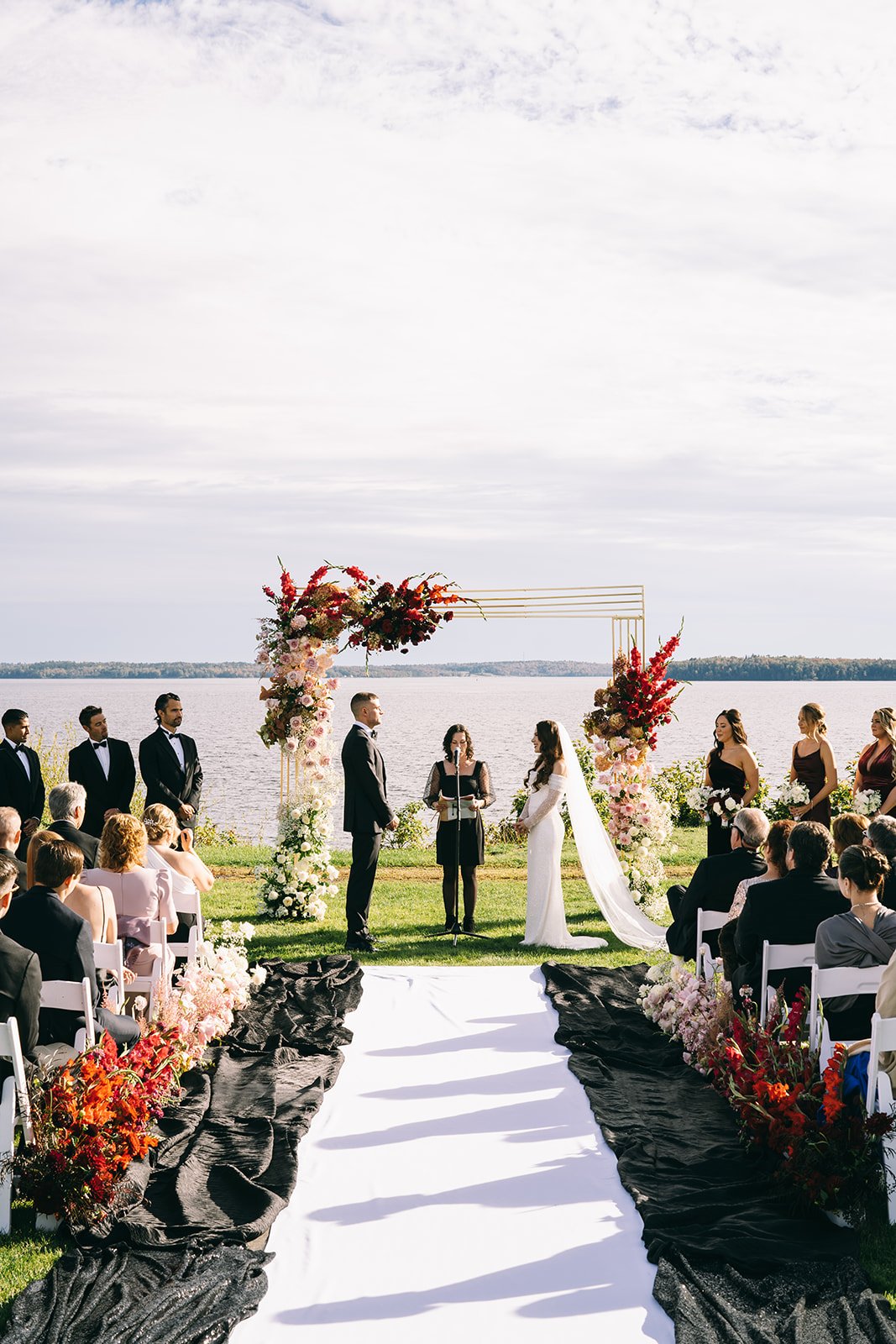Couple Stands at Ceremony Beneath Ombre Arbor