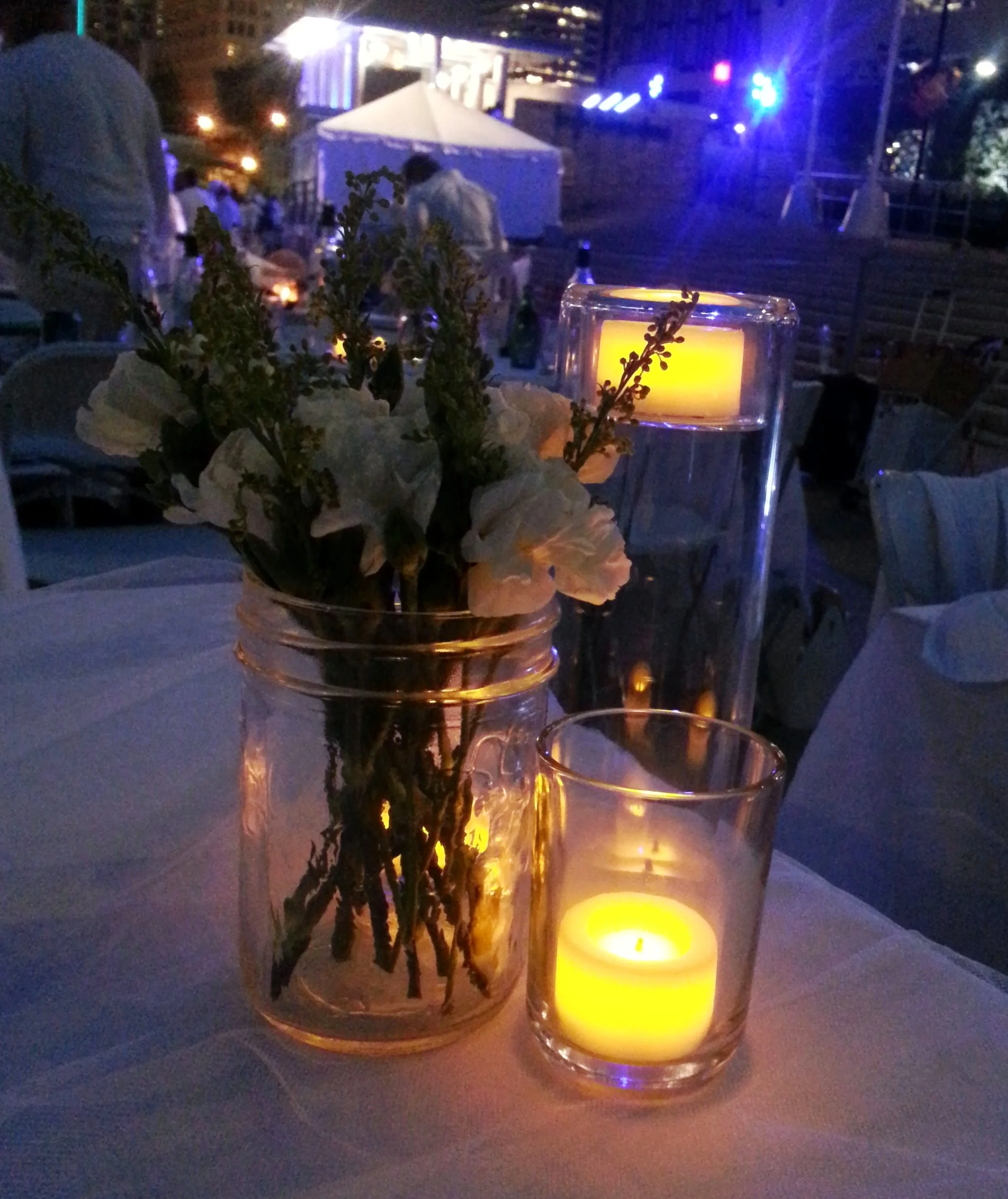 You will want light in the later parts of the evening, because it does get dark (also notice, there's no water in that jar of flowers - easier to carry that way). 