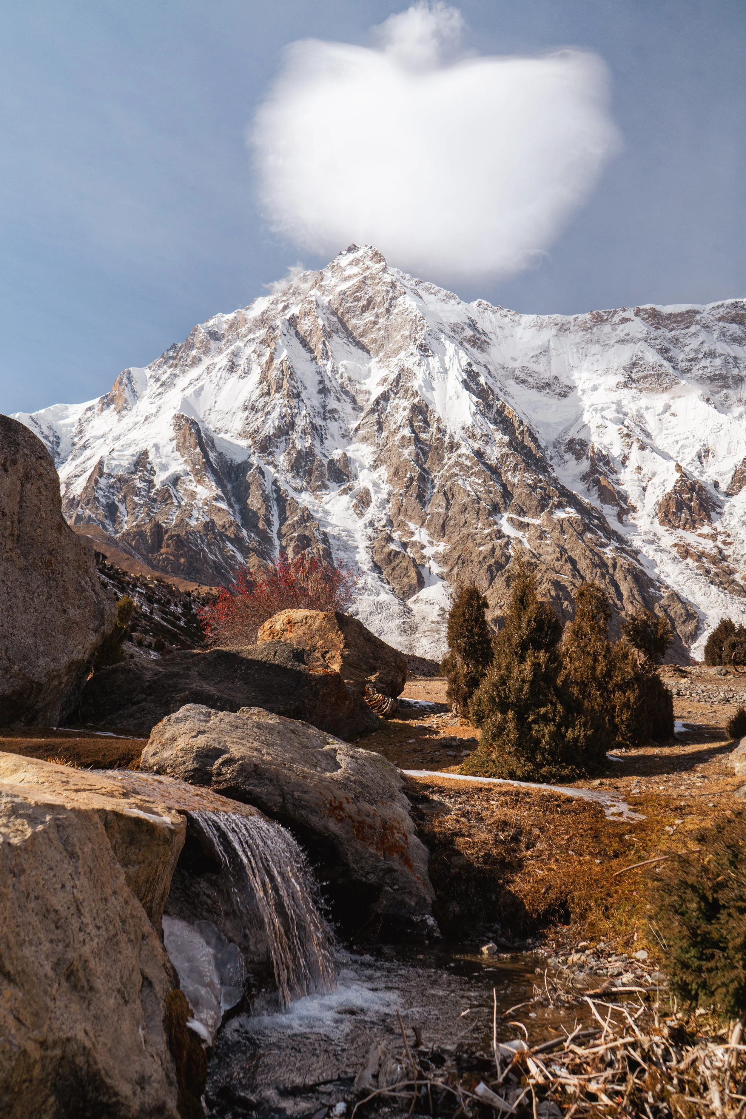 Nagna Parbat, The Naked Mountain, The Killer Mountain sits behind a waterfall at basecamp