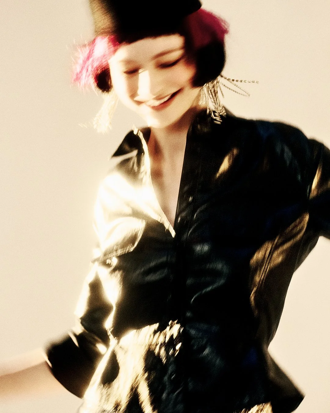 Dynamic black-and-white editorial shot of a model with magenta feathered accents and dramatic top hat, captured in motion for an exclusive PAP Magazine feature. Photographed by a leading London-based fashion photography specialist, this global vision