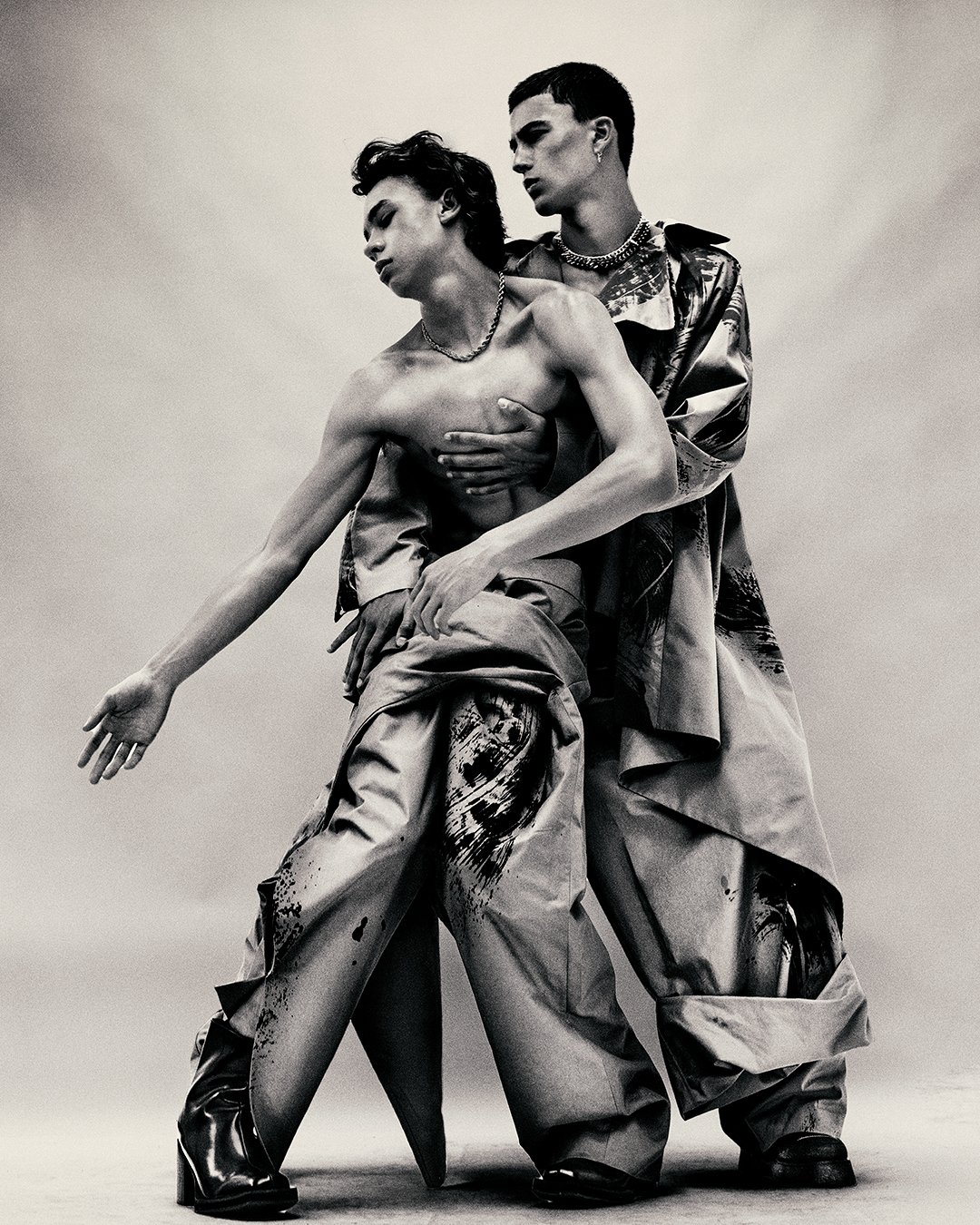 Image 1 Description:
Artistic black-and-white photograph of two models in an intimate pose, captured by a distinguished London fashion photographer. This global imaging specialist excels in editorial and commercial photography, delivering evocative s