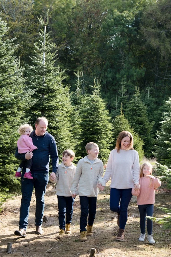 Family photoshoot in a Christmas Tree Farm woodland