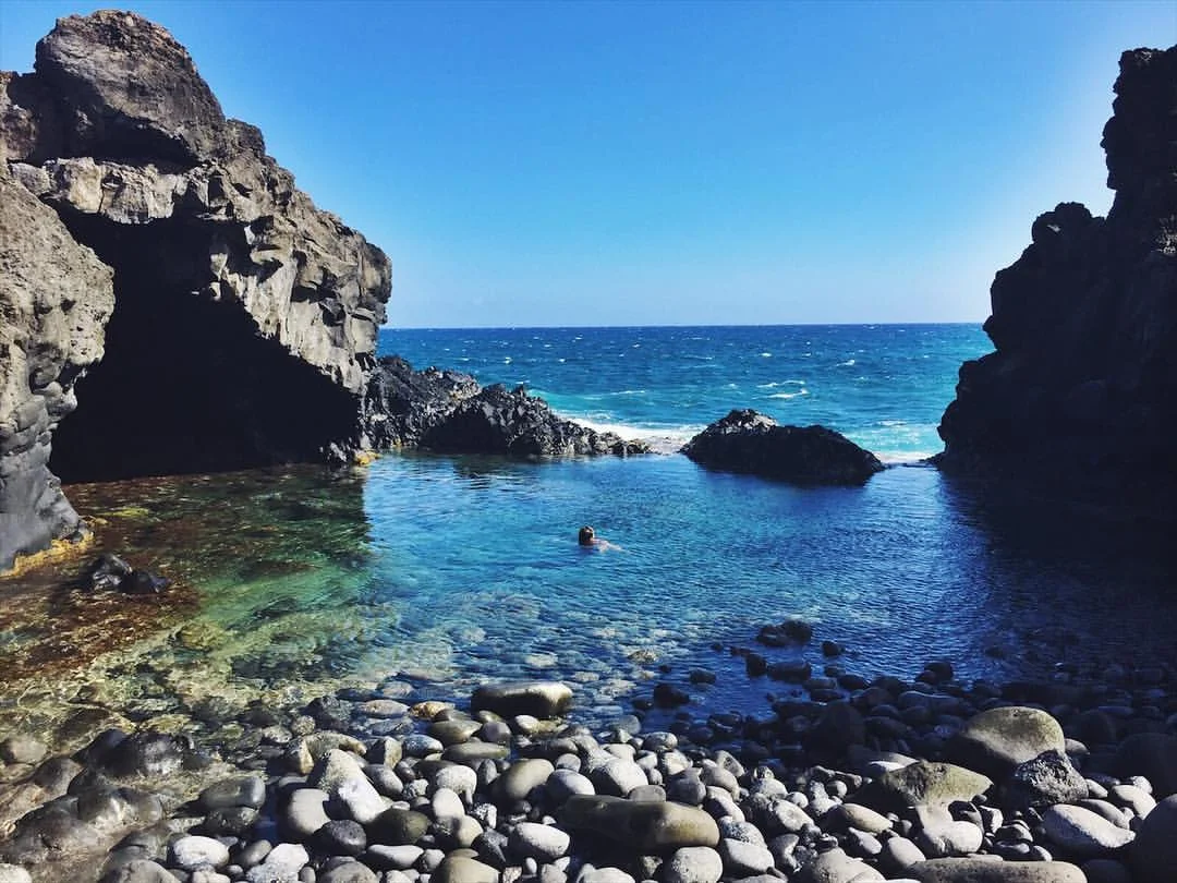 Swimming is ocean rock pools at the end of the Hoapili lava rock trail, on Maui, Hawaii.