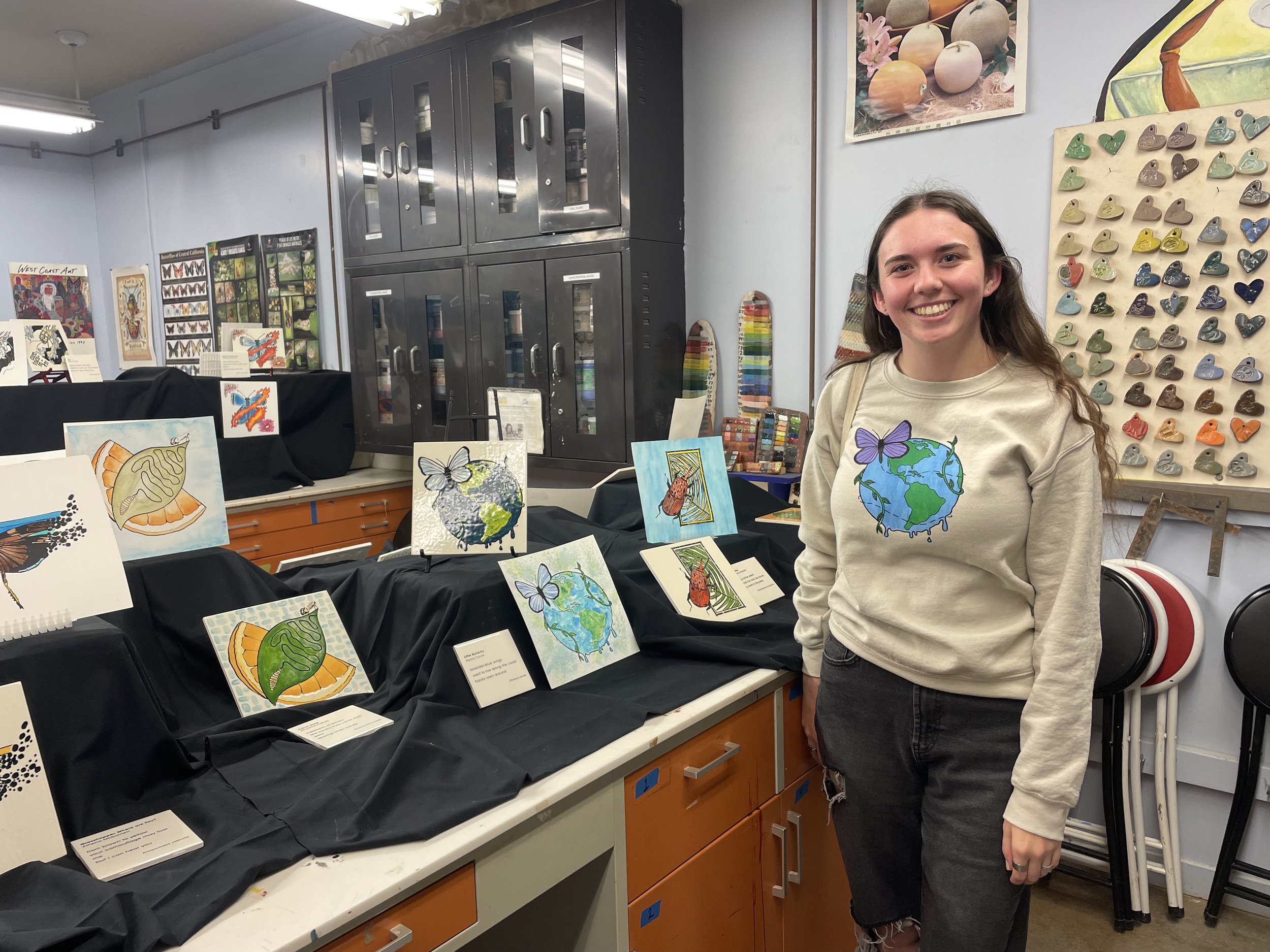 student wearing a sweatshirt screen printed with her artwork