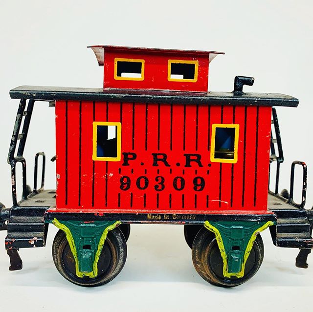 Circa 1906 Marklin red P.R.R caboose with original figure and stove in near mint condition.