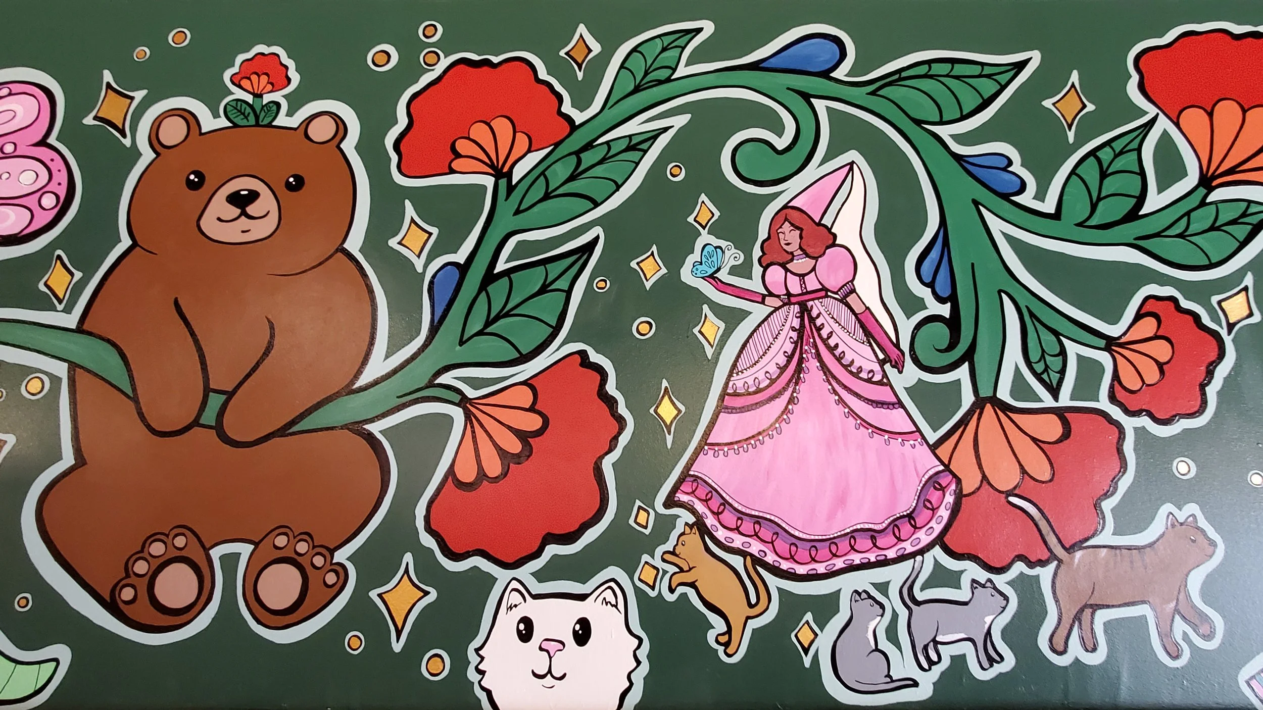 Another detail of the mural, depicting a happy bear hanging from a vine, a princess in pink with four cats at her feet