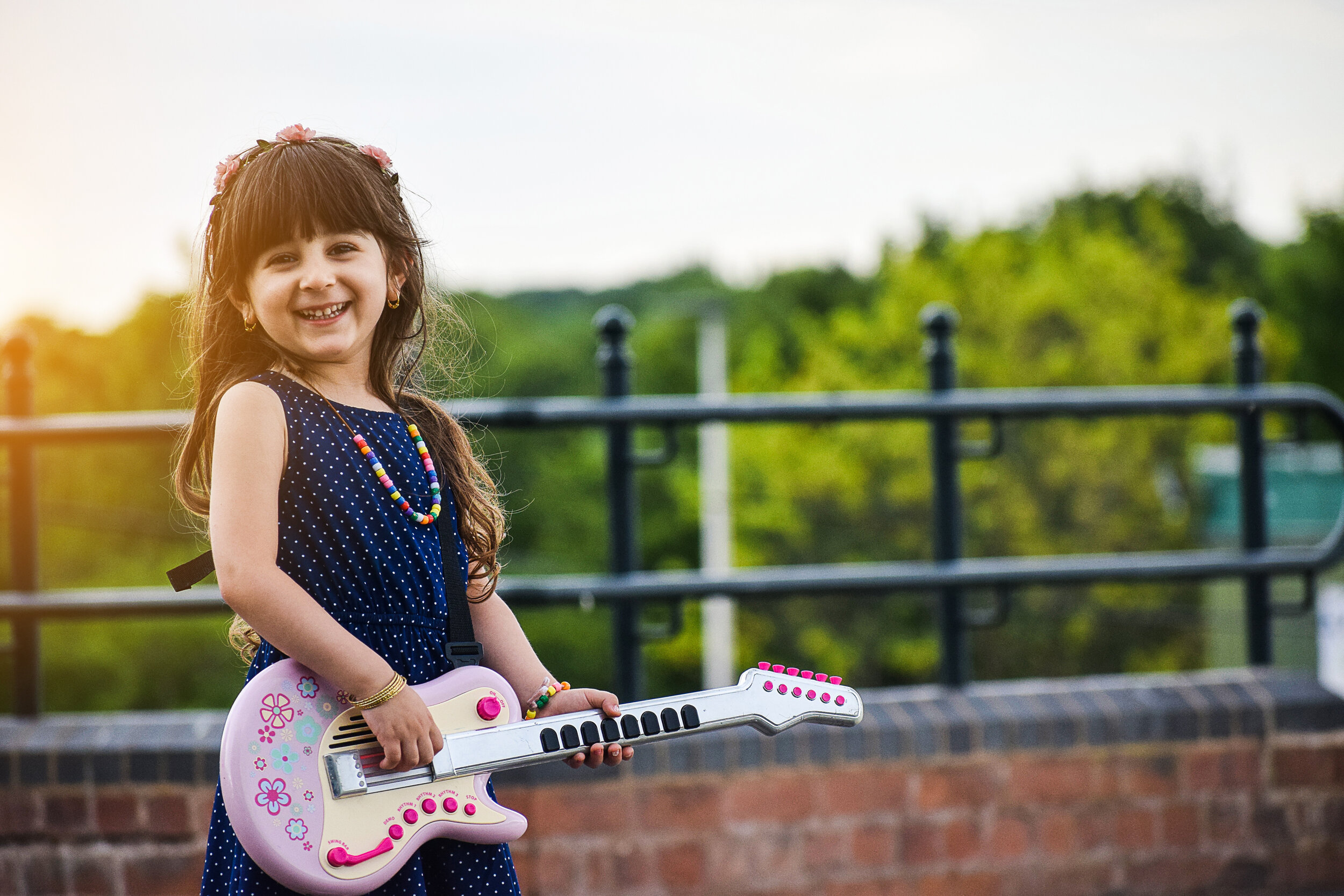 Canva - Little Happy Girl Playing Guitar.jpg