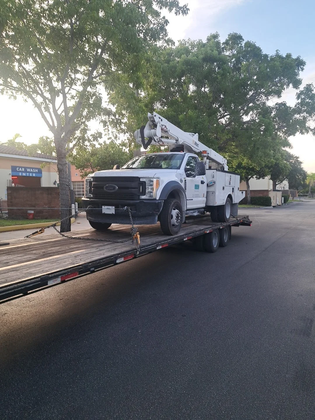 Inoperable work truck being loaded via winch.