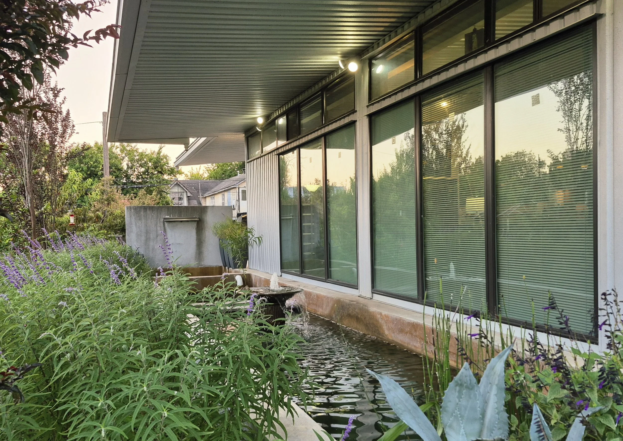 Massive roofs harvest rainfall, with storage below for garden irrigation and passive cooling