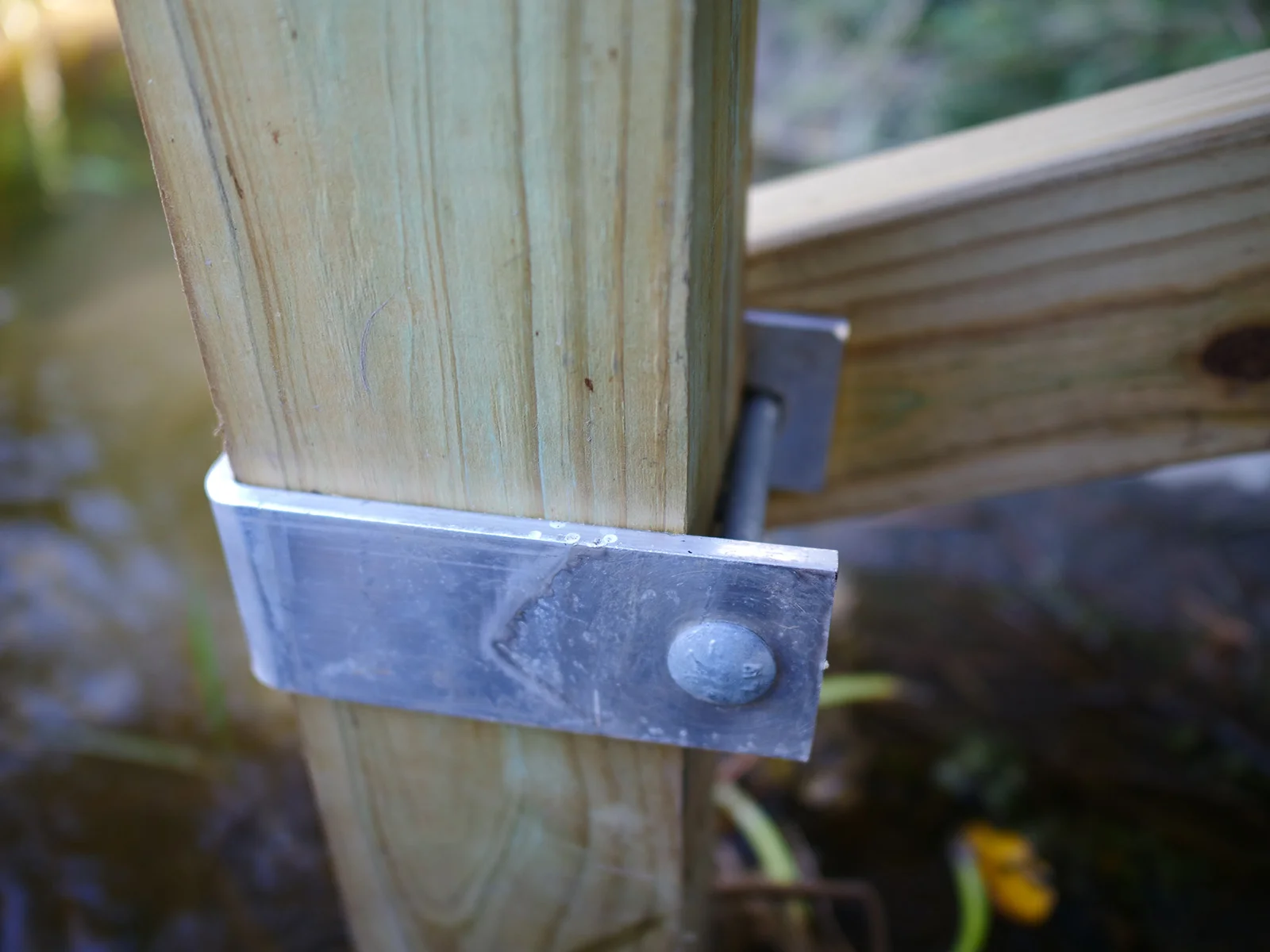 Brace Clamp holding the 2x4 PT cross brace end. Allows for future easy adjustment.