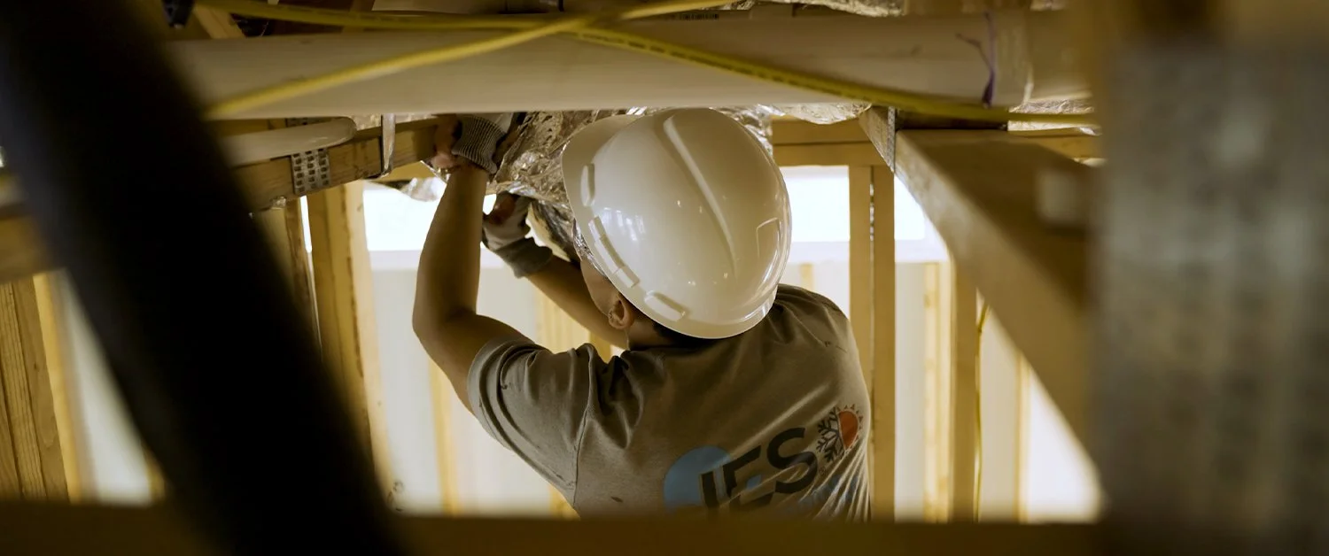 HVAC construction employee filmed working in an attic by UPTIME Films for marketing videos