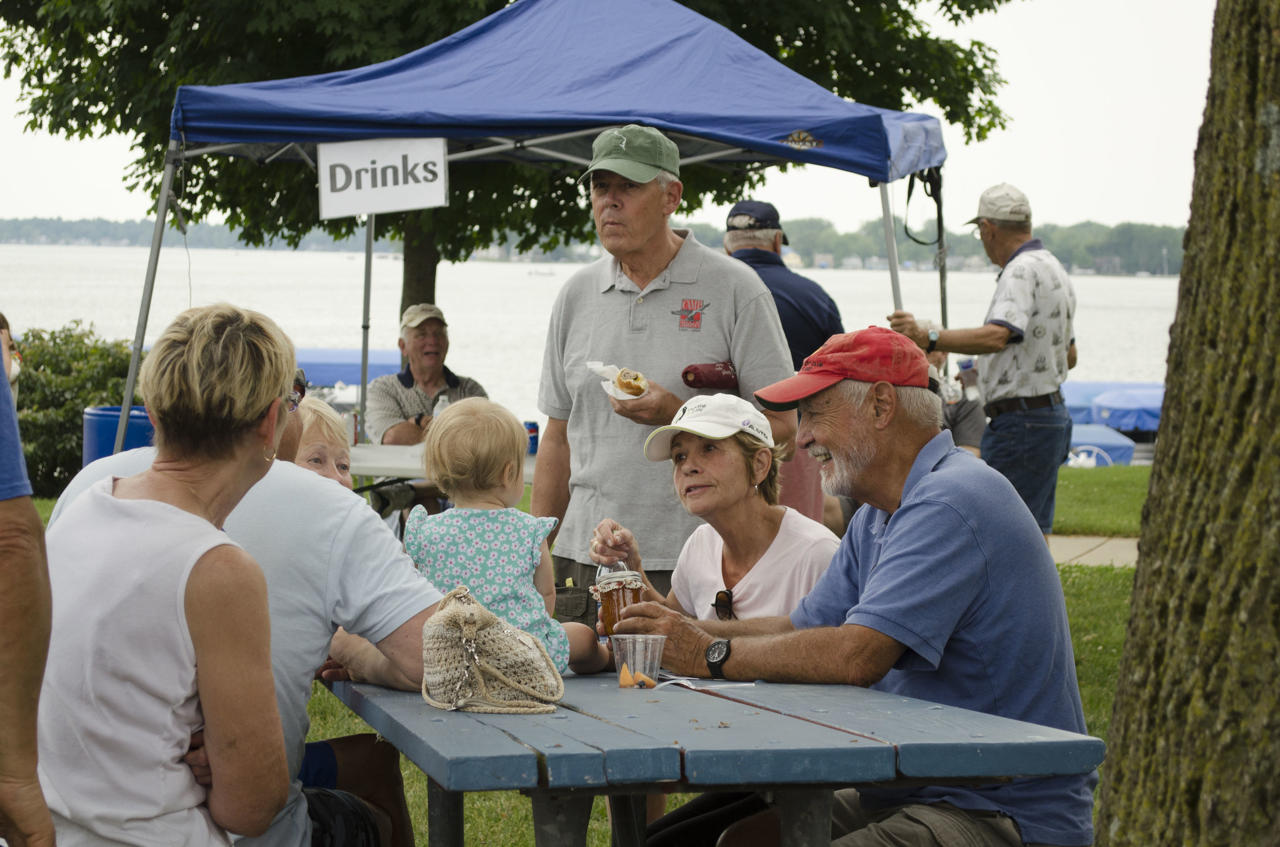 Attendees sit in the park and enjoy food from a variety of vendors.