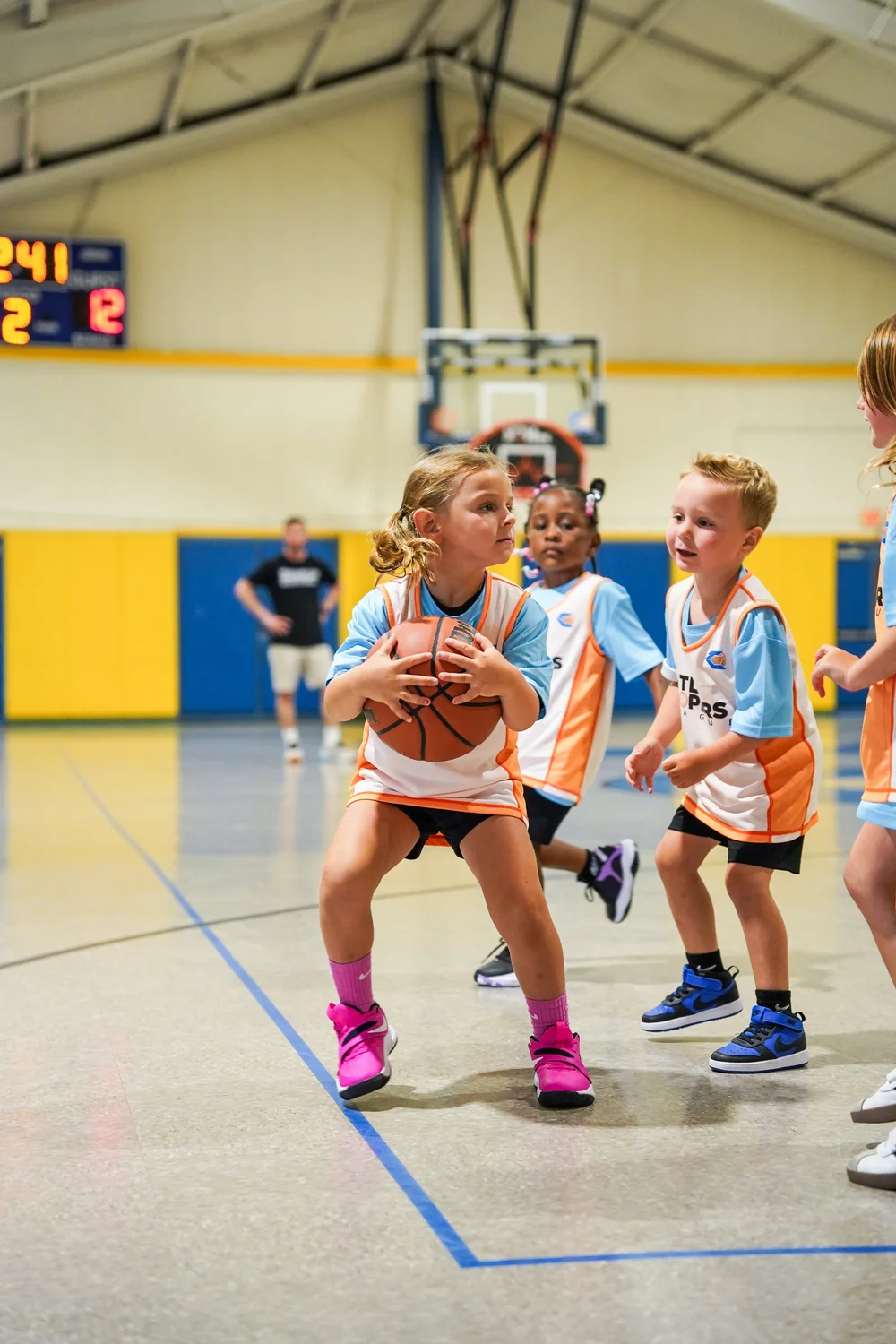 Young beginner basketball player participating in Little Hoopers