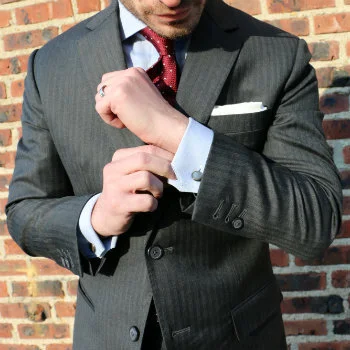 Man-adjusting-sleeve-of-power-suit.jpg