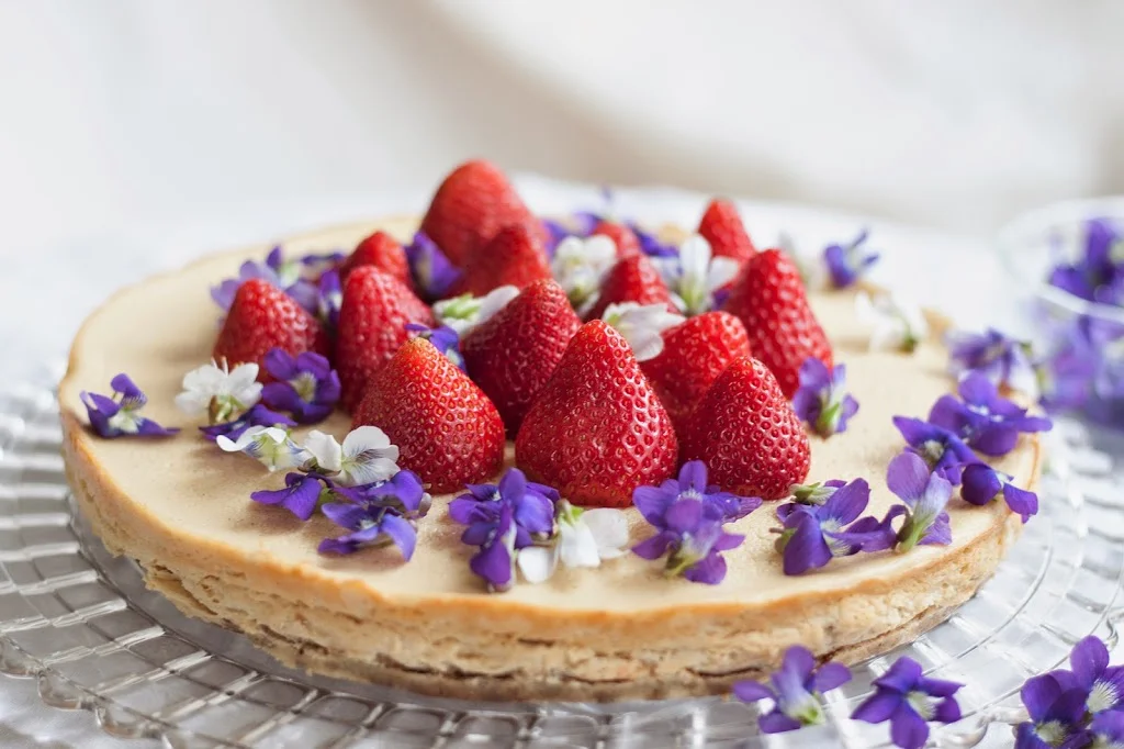 CHEVRE CHEESECAKE W/ STRAWBERRIES, EDIBLE FLOWERS, PISTACHIO CRUST (GLUTEN FREE)