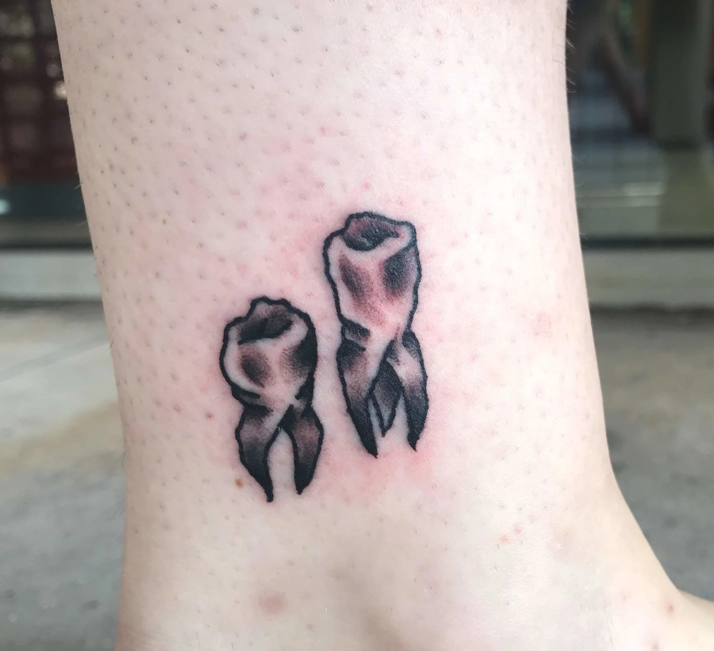 Two small teeth tatttoos.