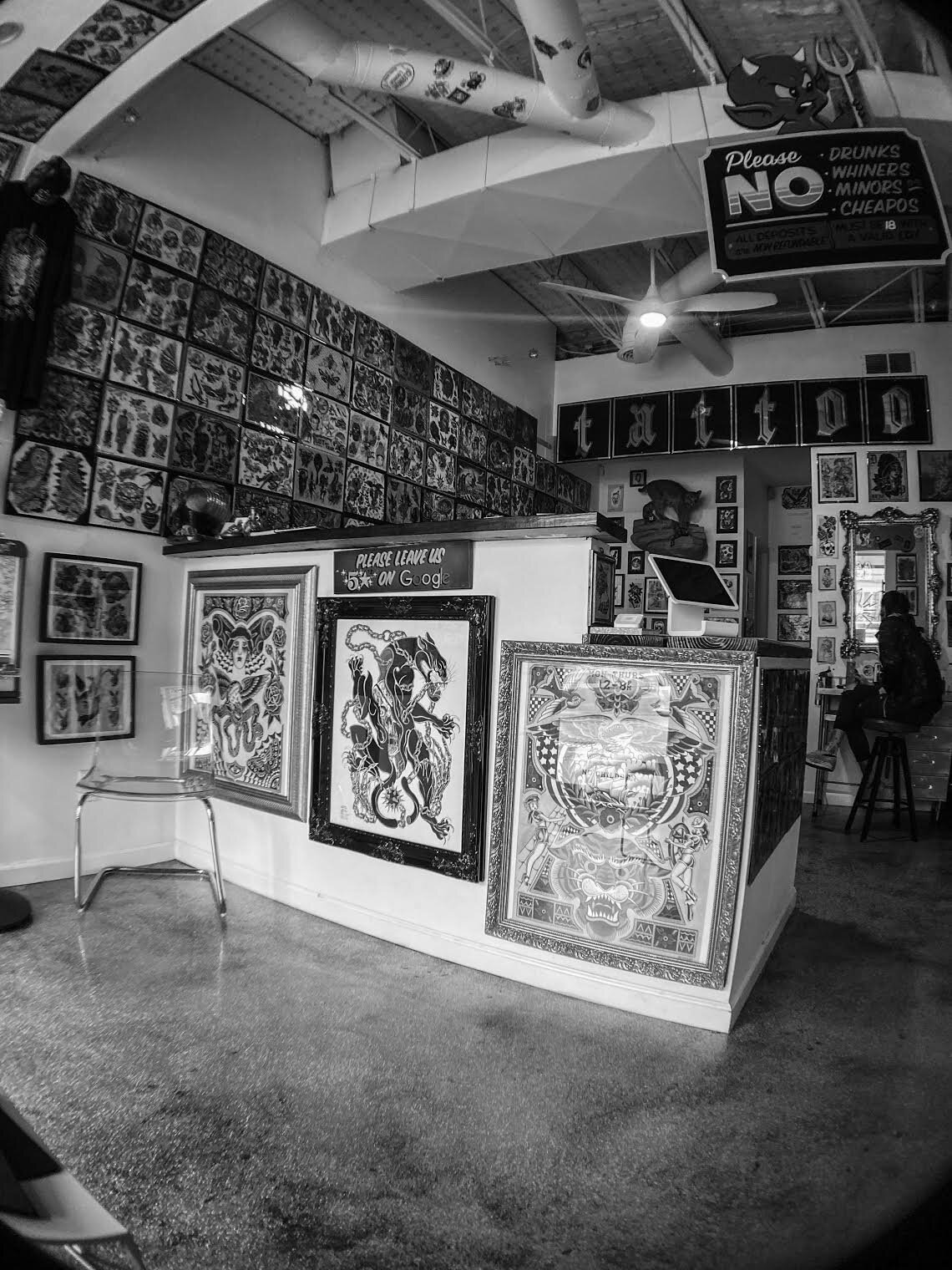Tattoo shop showing flash sheets for 2026 trends