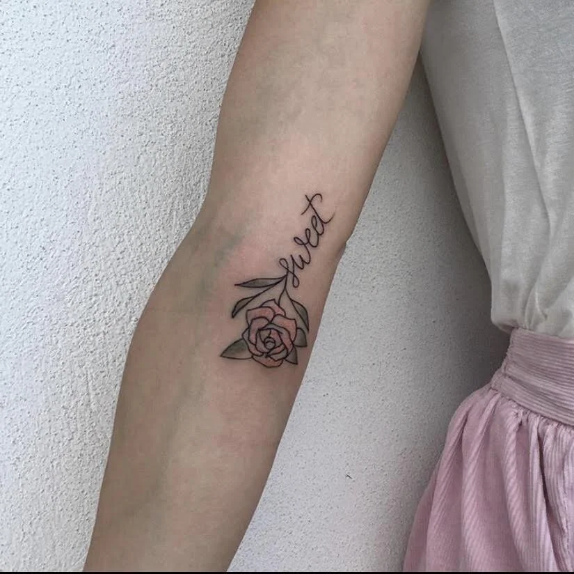 Small fine line tattoo of a flowerwith the word sweet.