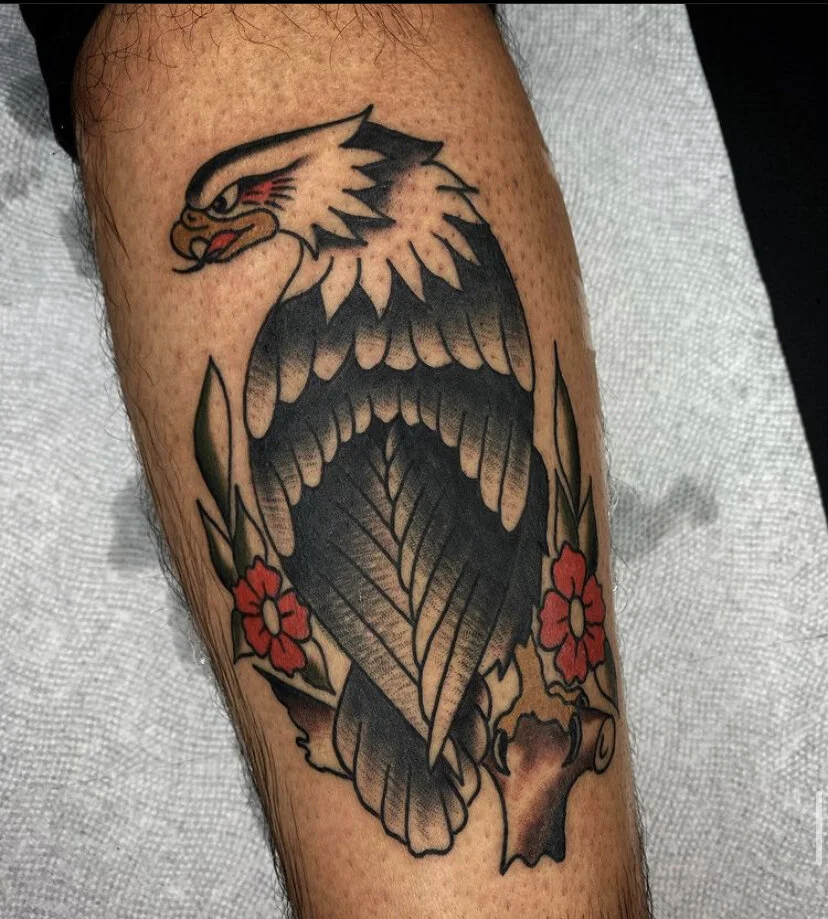 American traditional eagle tattoo with bold black outlines and classic red and yellow shading