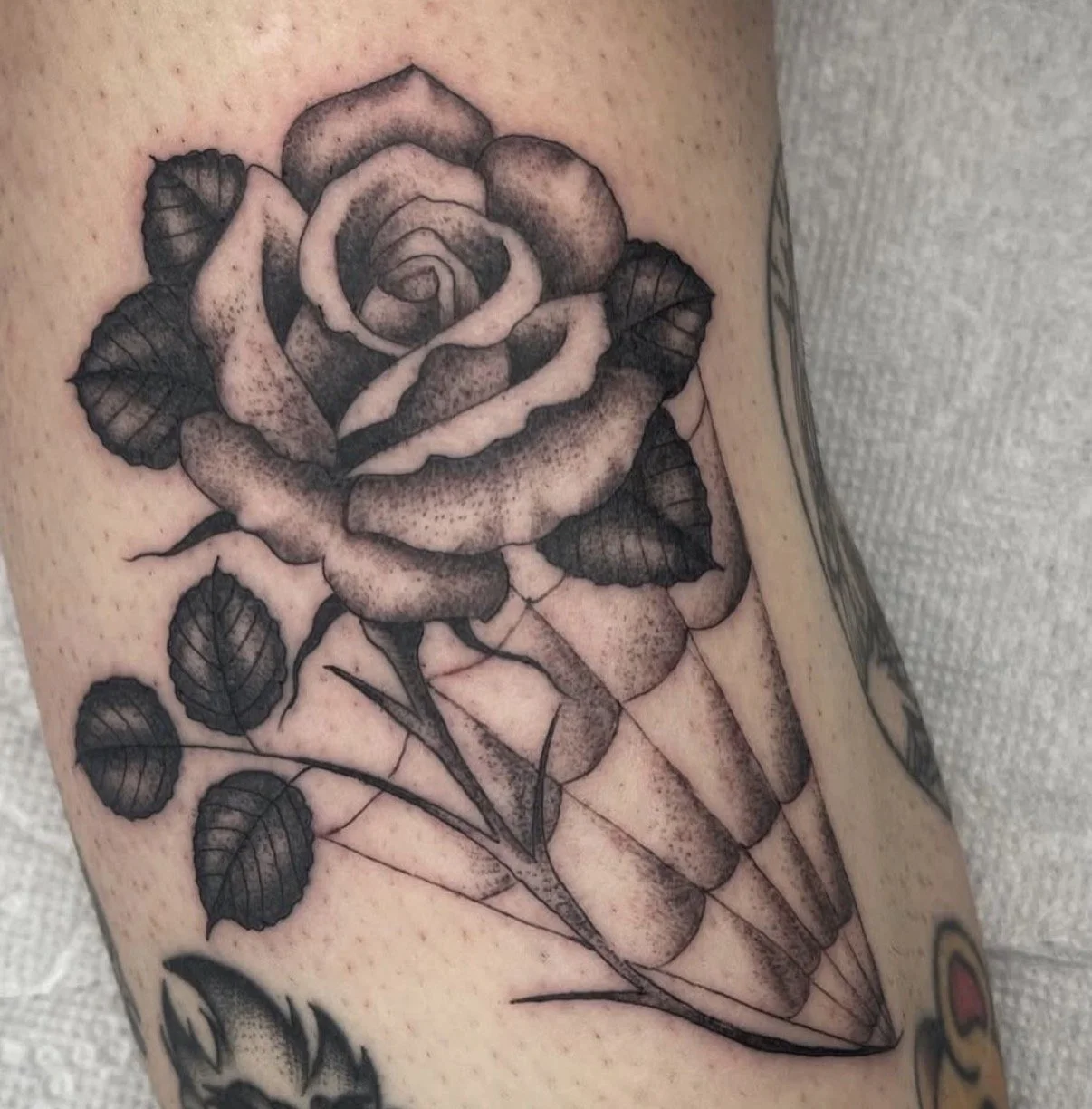 Fine line rose tattoo with detailed shading and illustrative style