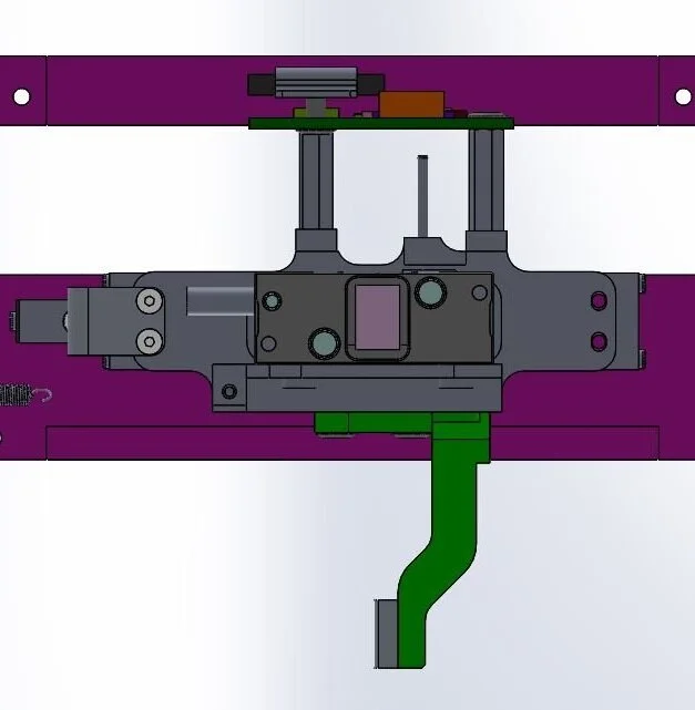 The new design reduced the compliance of the part by drastically shortening it and placing the encoder directly over the rollers.
