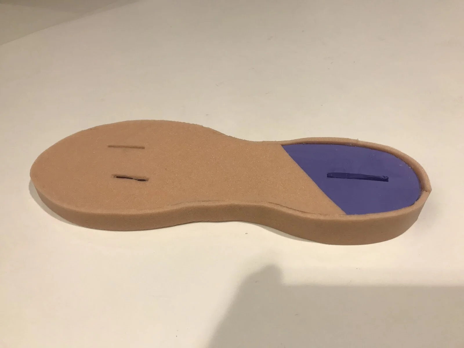 Top of finished insole with felt cover.