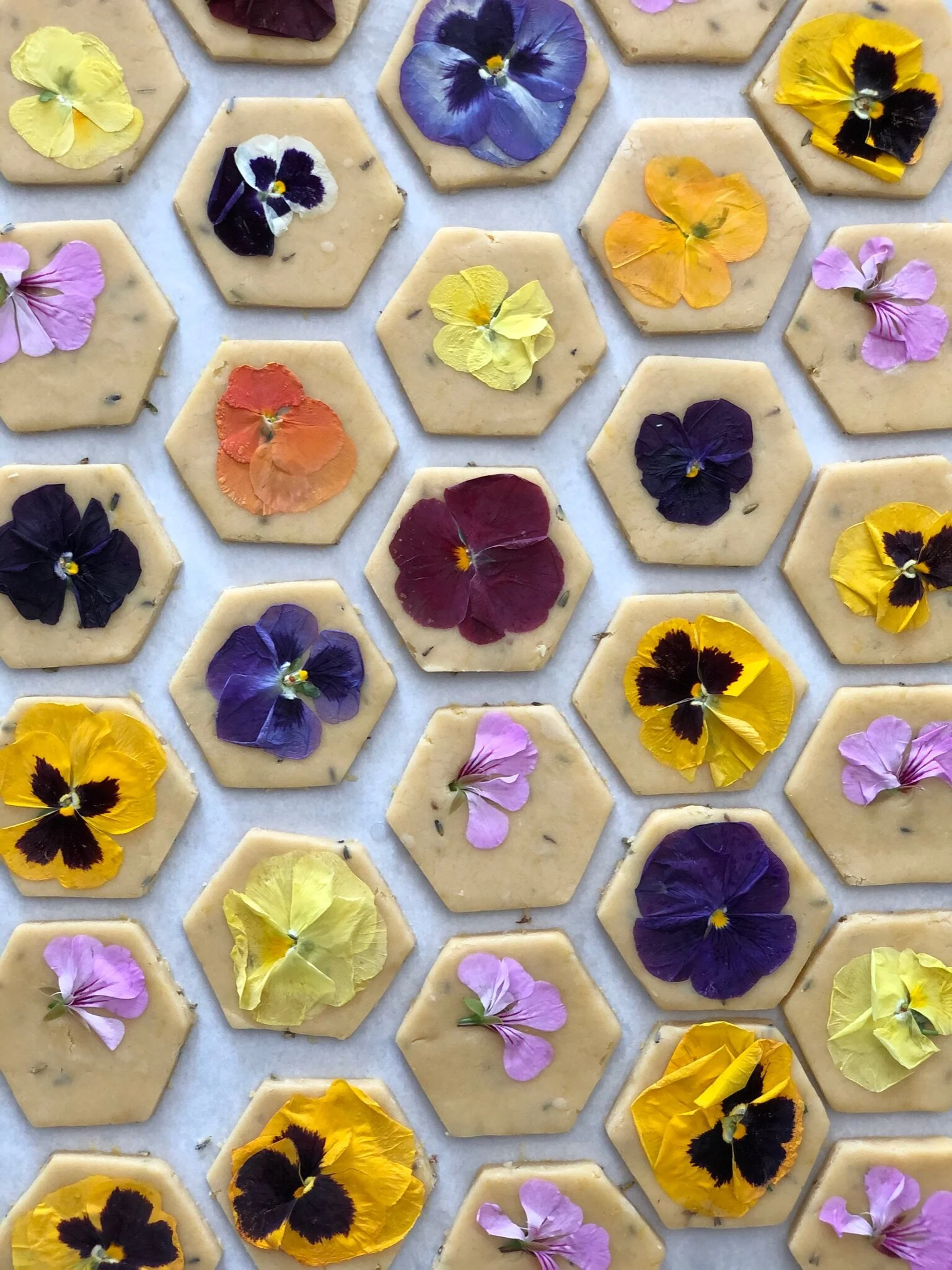 Buttery shortbread cookies flavored with seasonal citrus zest and pressed with local farm fresh edible blooms