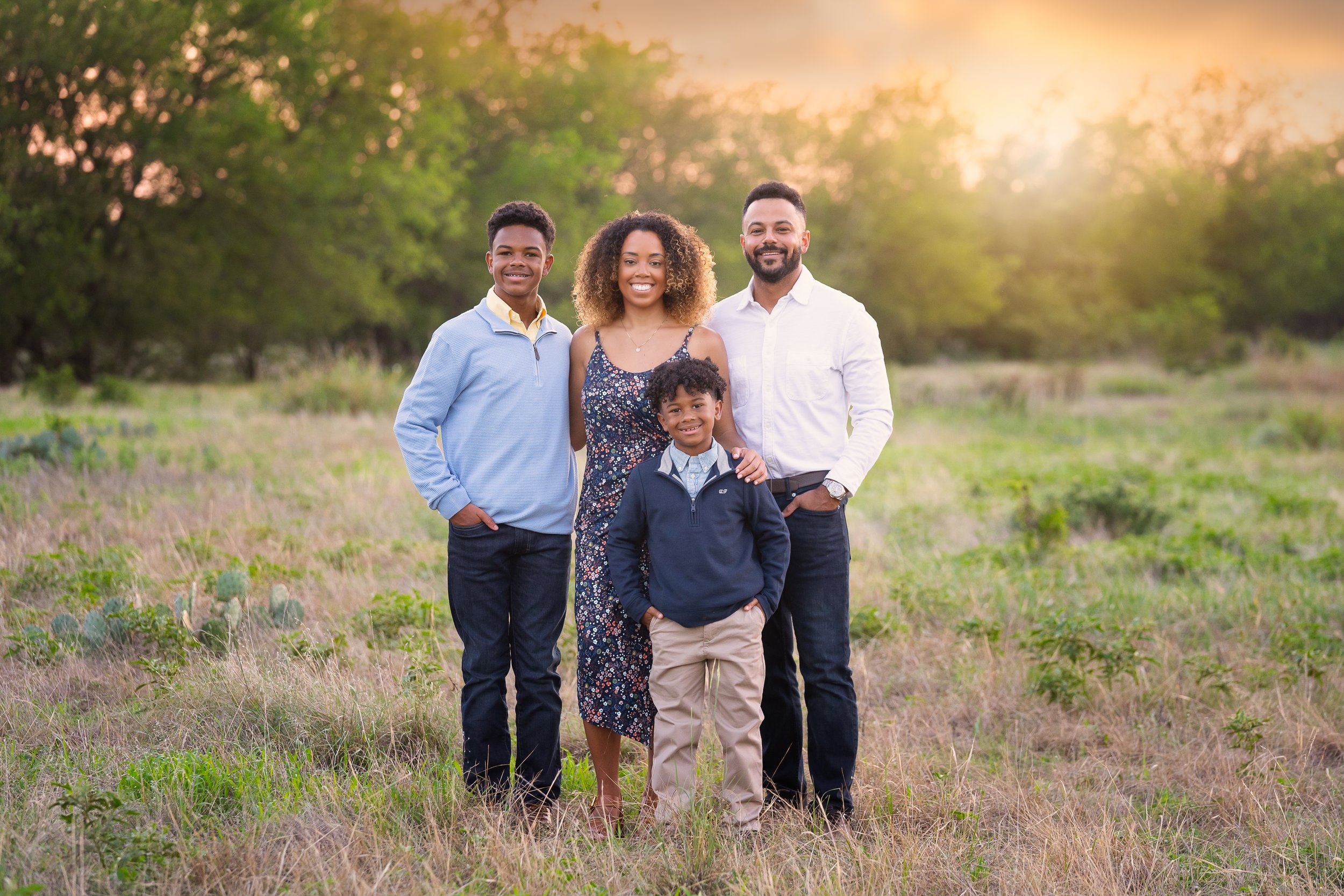 Beautiful fall family portraits in a field with a sunset in Fort Worth TX
