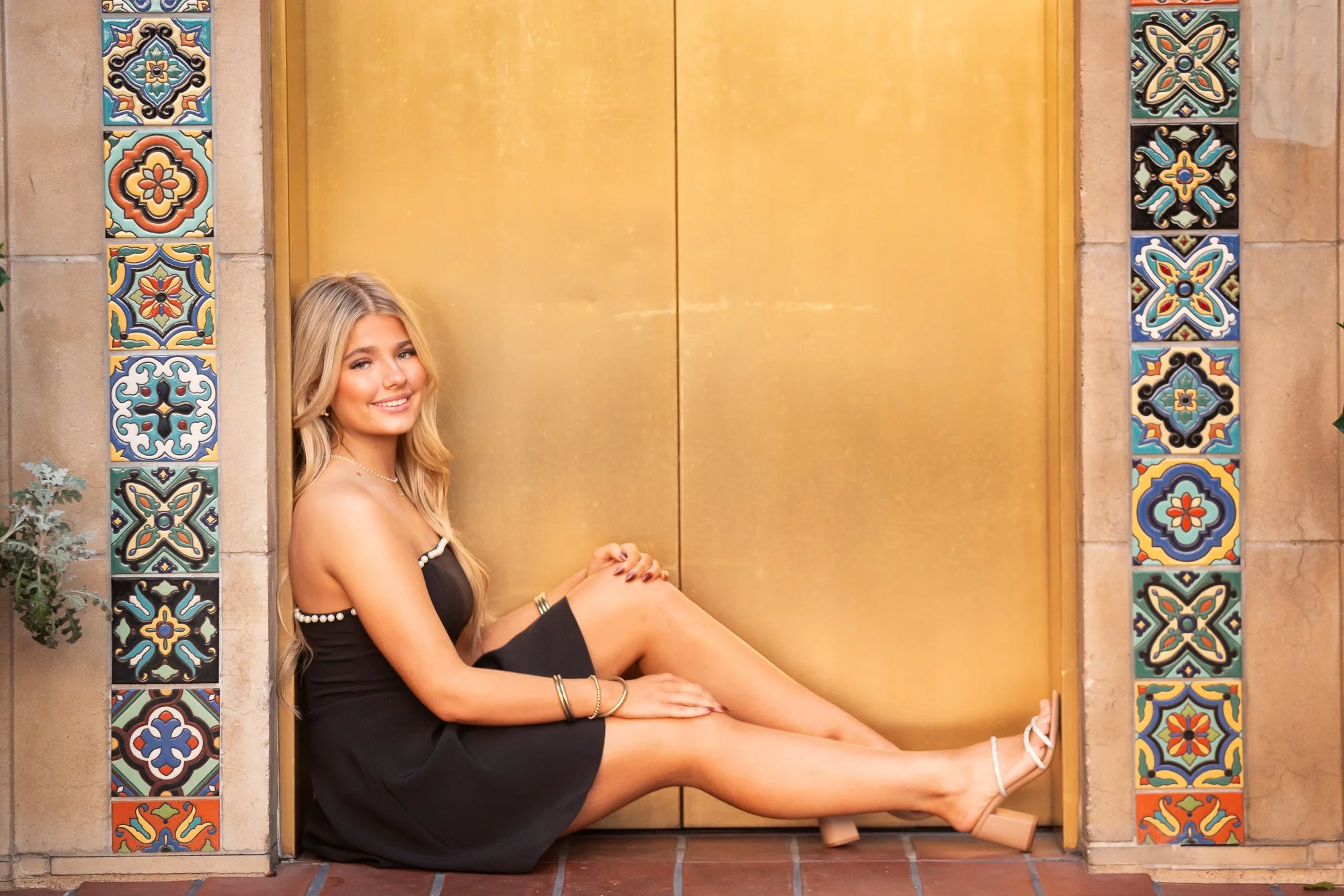 Urban senior portraits in front of gold elevator Dallas