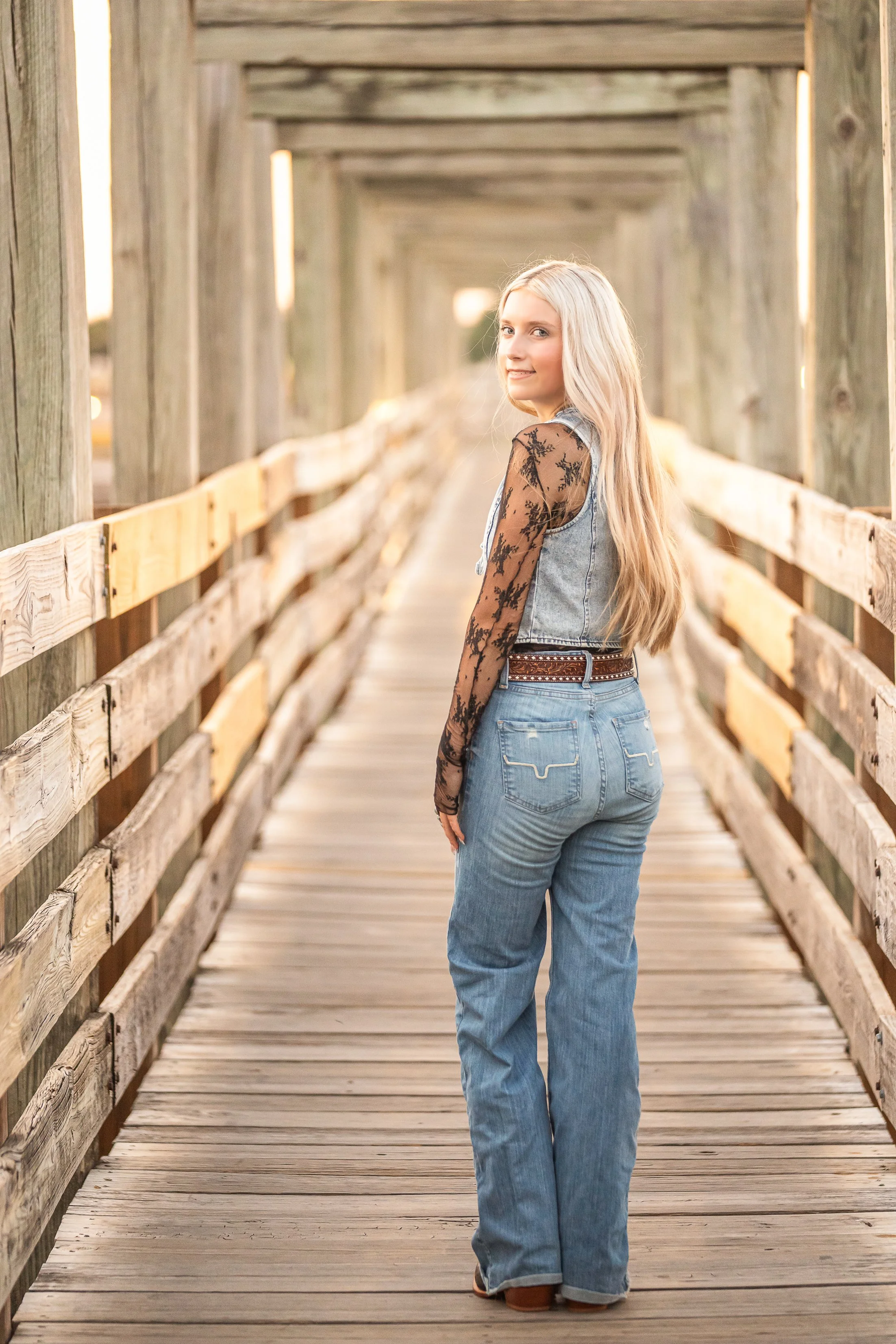Senior portraits on cattle bridge in Fort Worth Stockyards