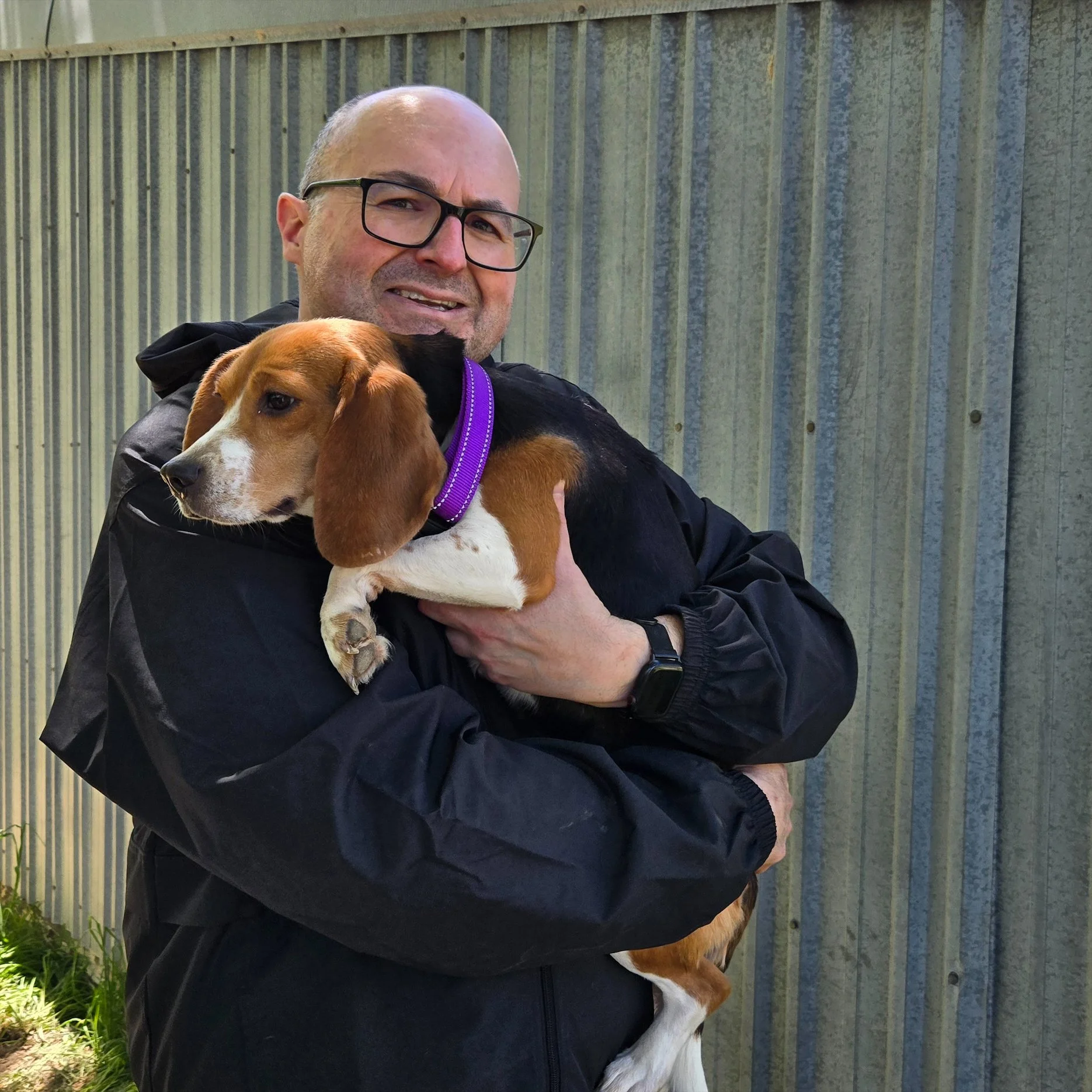Paul Collins carrying a rescued Beagle